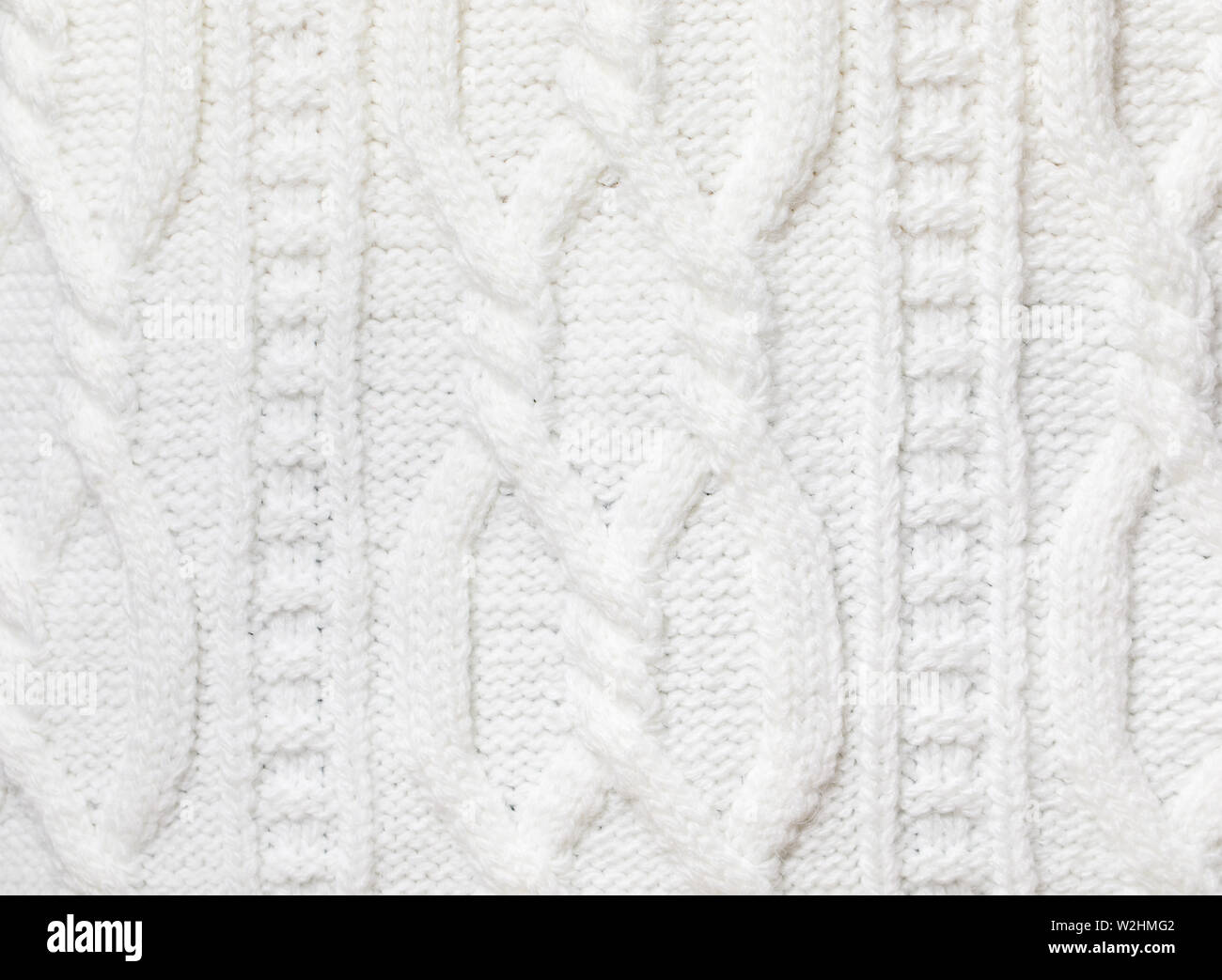 Real white knitted fabric with  cable pattern textured background Stock Photo
