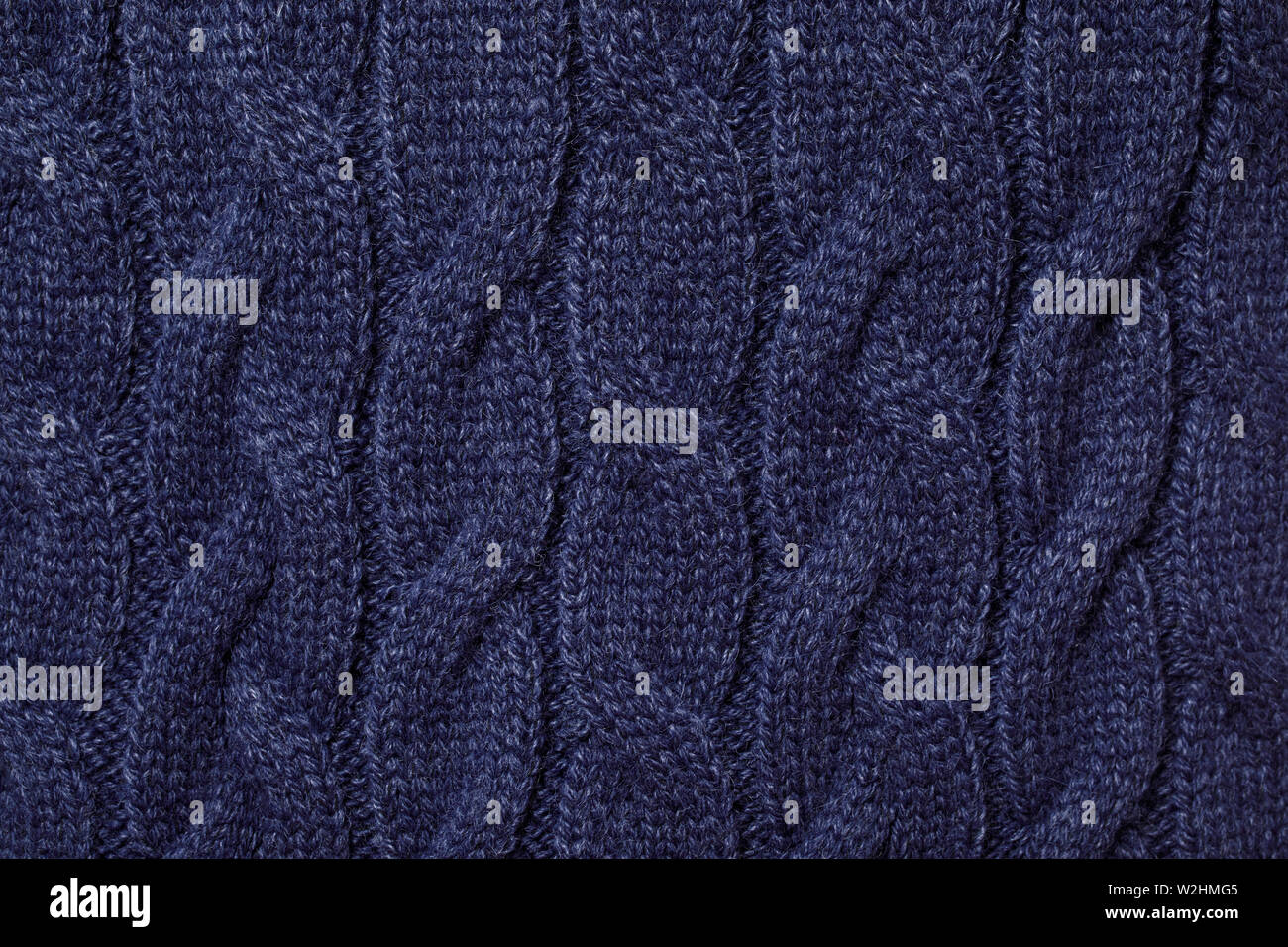 Real blue knitted fabric with  cable pattern textured background Stock Photo
