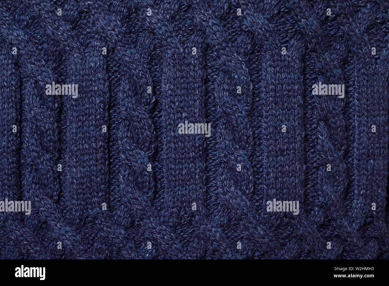 Real blue knitted fabric with  cable pattern textured background Stock Photo