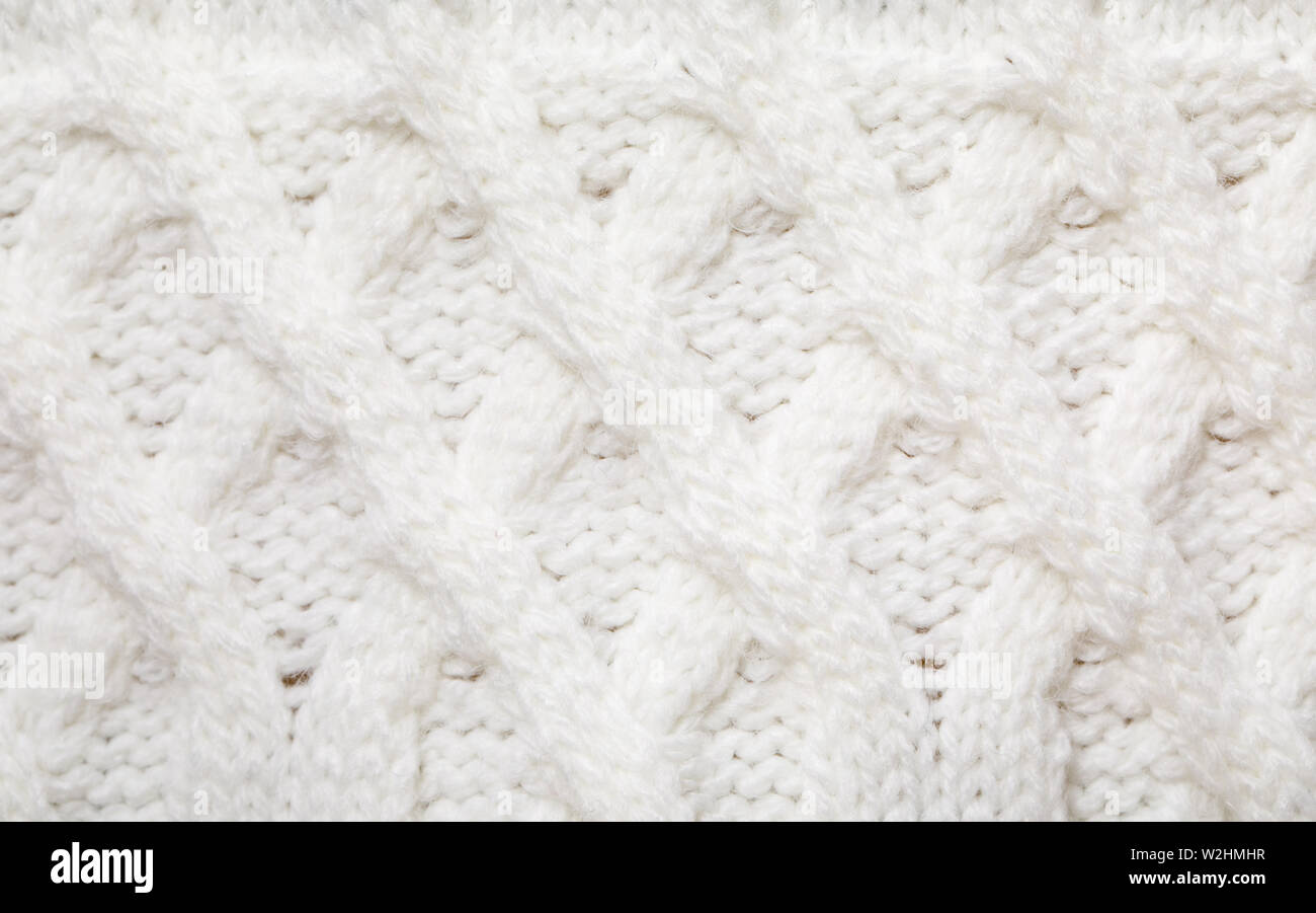 Real white knitted fabric with  cable pattern textured background Stock Photo