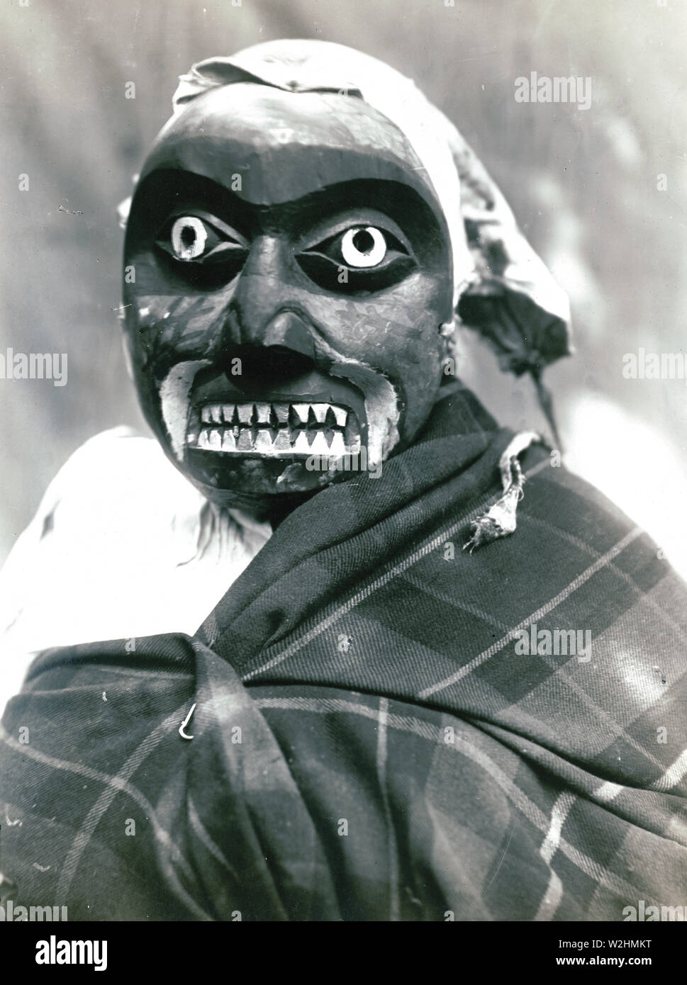 Ceremonial mask worn by a dancer portraying the hunter in Bella Bella mythology who killed the giant man-eating octopus. The dance was performed during Tluwulahu, a four day ceremony prior to the Winter Dance. Stock Photo