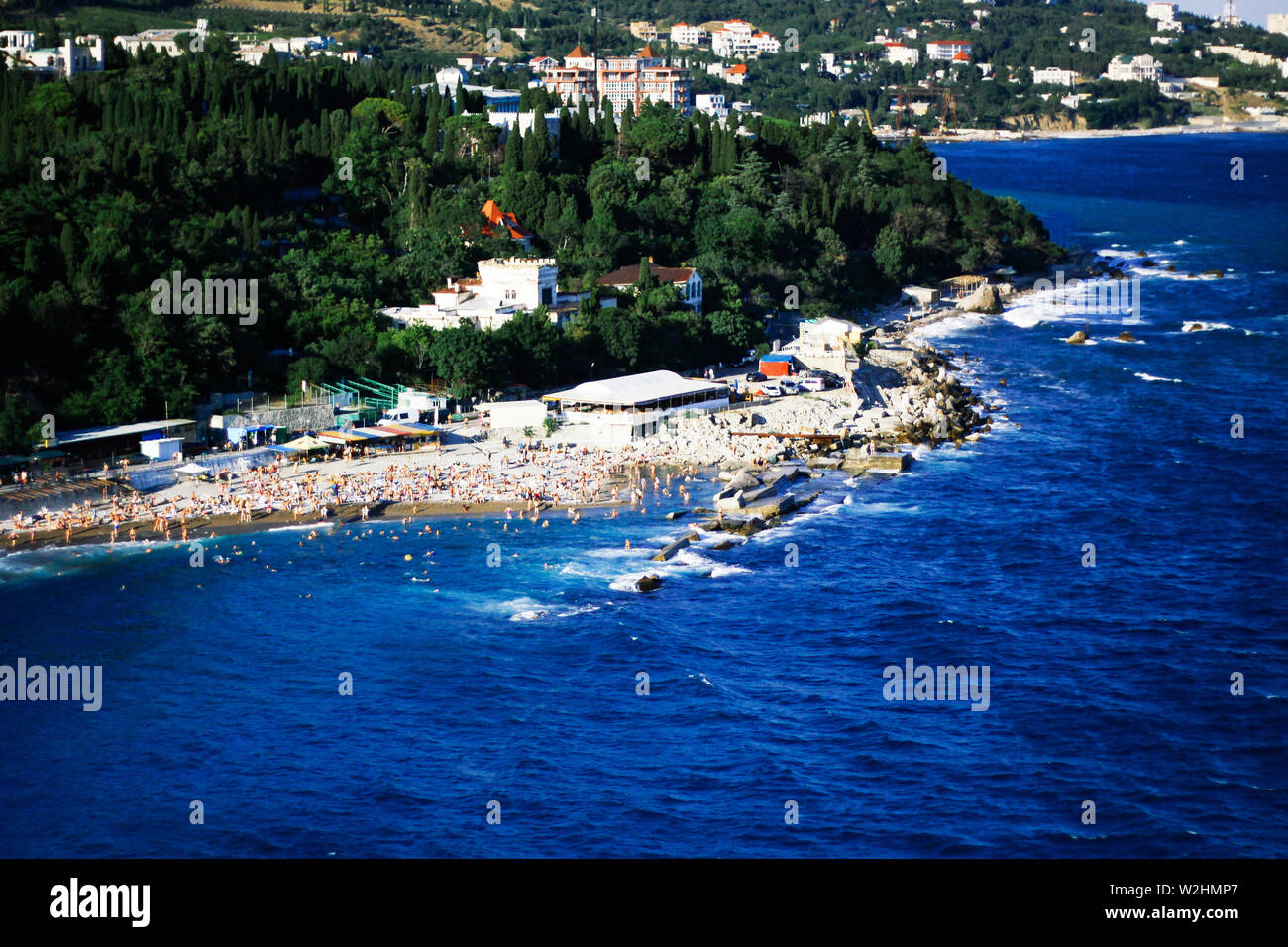 Top view, view of the Black Sea coast during a storm beach full of tourists and rubbish. Tourist area. Beaches by the sea. Post-Soviet space. Stock Photo