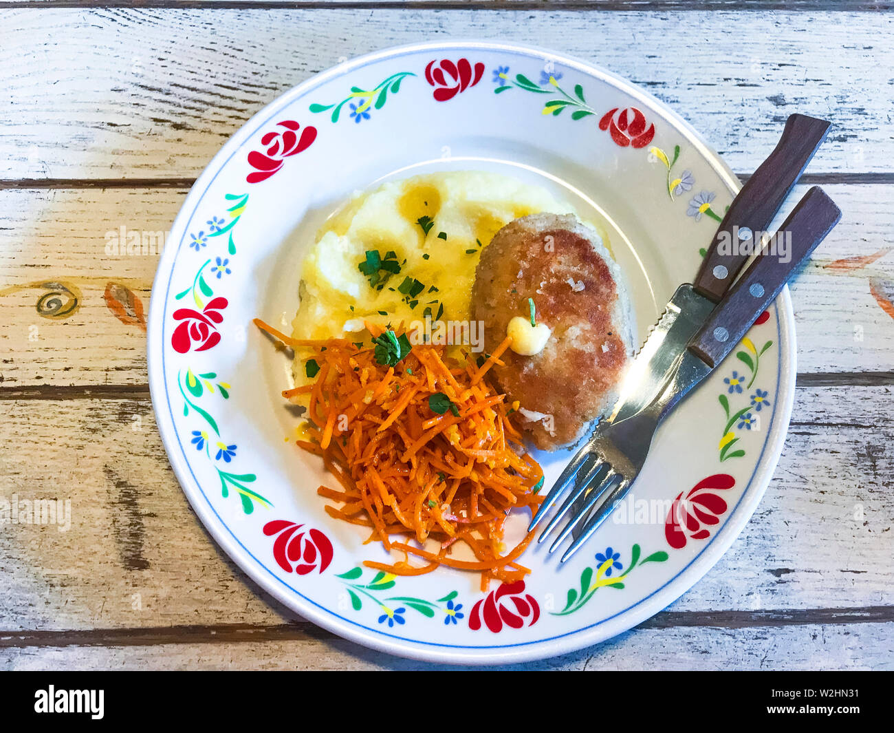 Rustic lunch on color plate, wooden background Stock Photo - Alamy