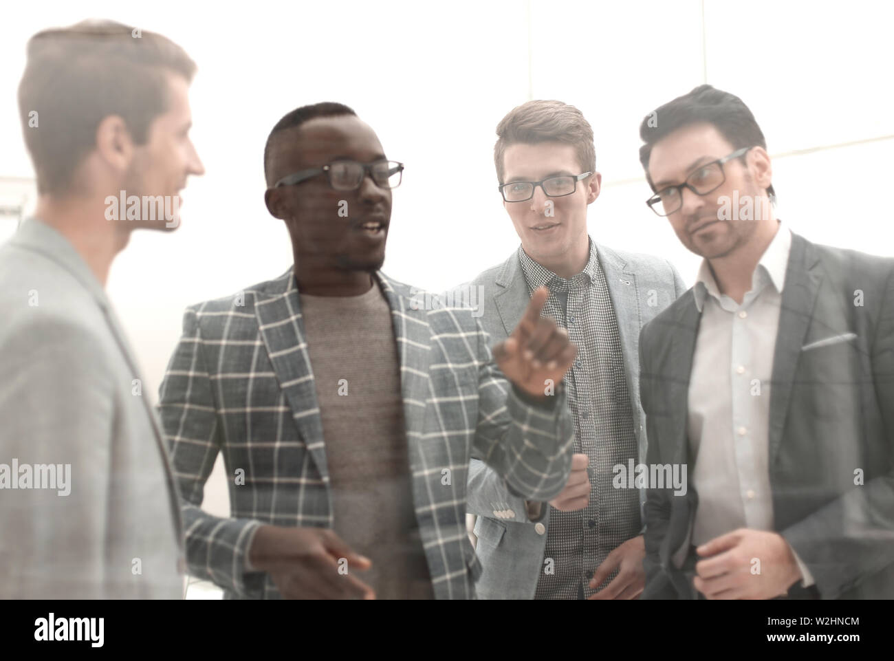 close up.business team talking standing in the office Stock Photo - Alamy