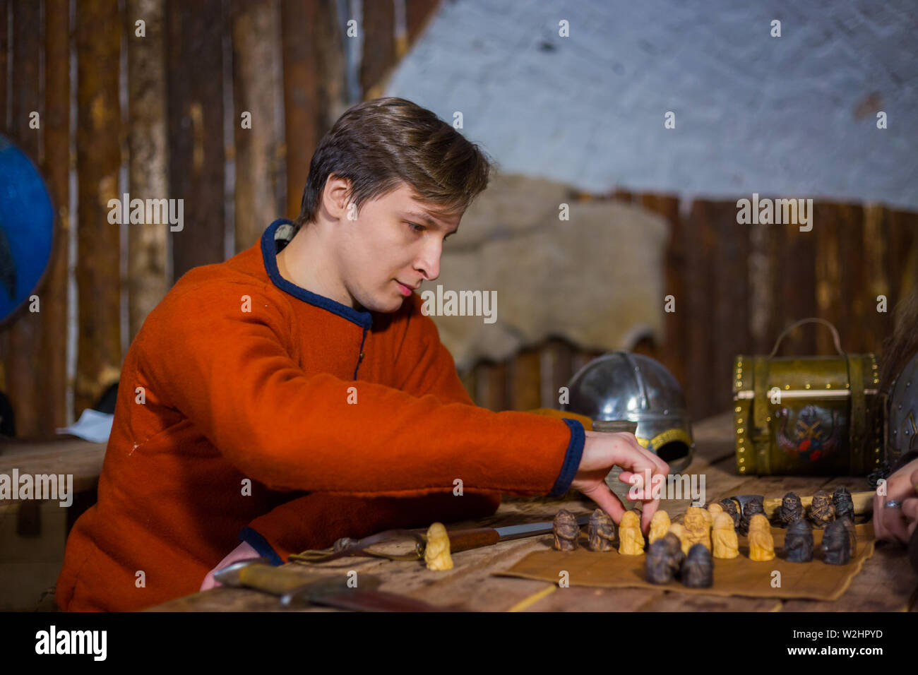 Portrait of man in russian ethnic suit playing chess Stock Photo