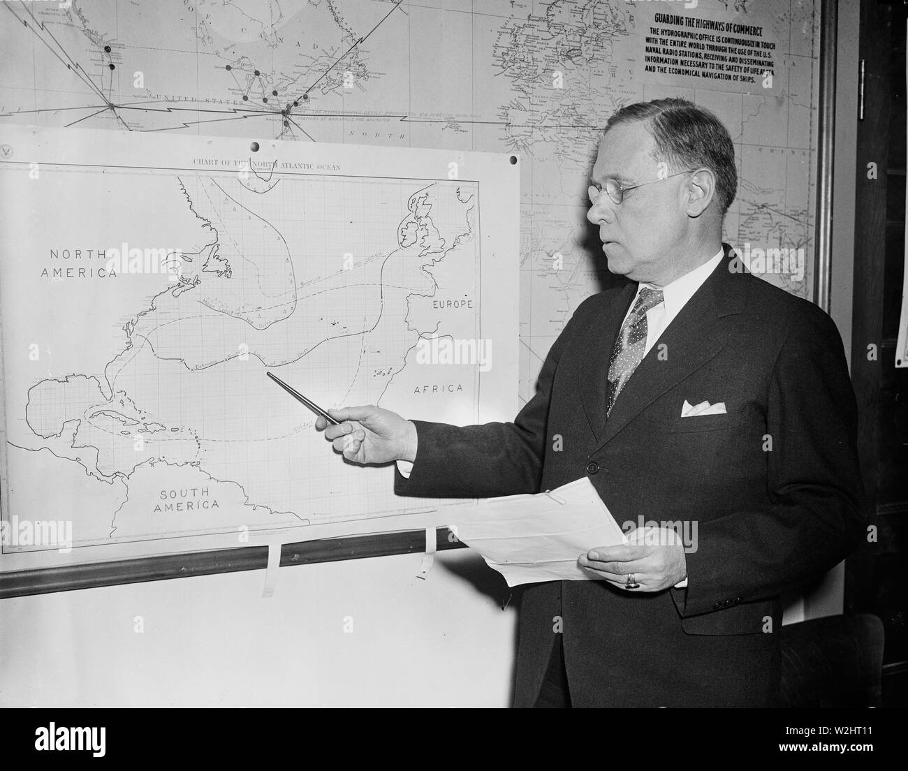 Man with chart showing North Atlantic Ocean ca. 1936 Stock Photo