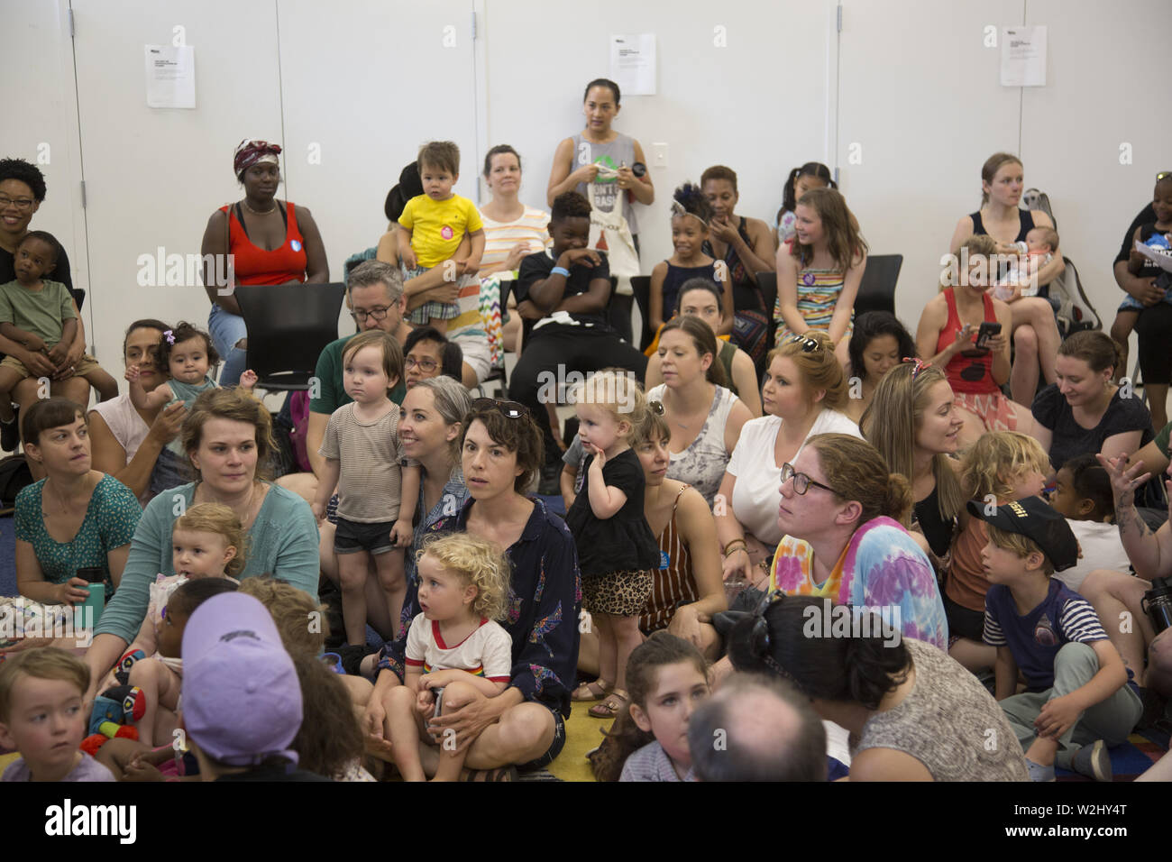 Drag Queen Story Hour, a national organization runs programs intended to instill a love of reading in young kids and also seeks to spread messages about self-love, acceptance of others and appreciation of diversity: Parents & children listen to a story at the Crown Heights Stock Photo
