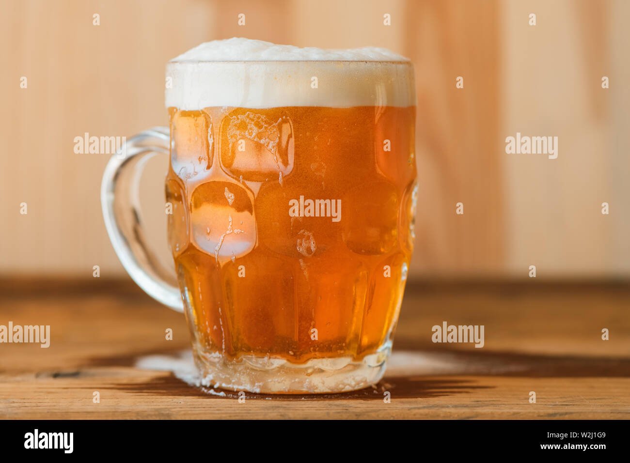 Beer mug on bar counter, single drinking glass with fresh alcohol beverage Stock Photo