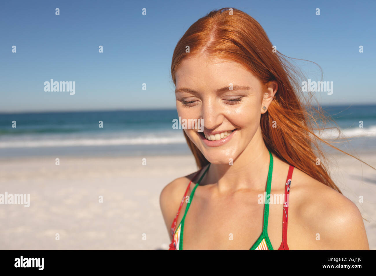 Happy woman standing on the beach Stock Photo - Alamy