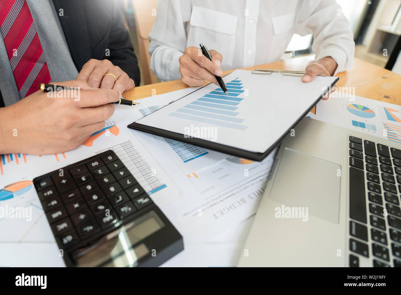 businessmen discussing project at meeting pointing explaining his idea ...