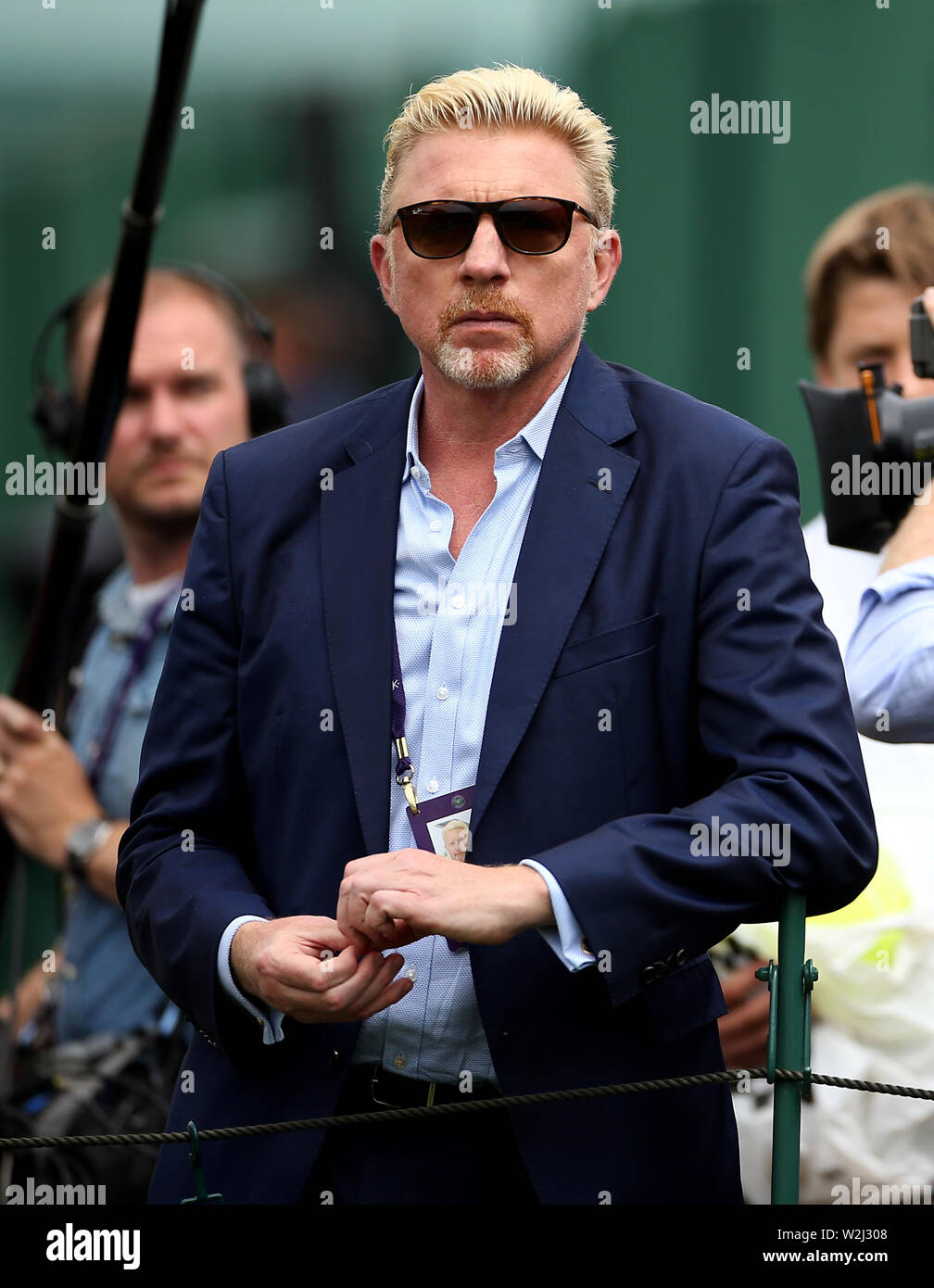 Boris Becker watches the action on the outside courts on day eight of the Wimbledon Championships at the All England Lawn Tennis and Croquet Club, Wimbledon. Stock Photo
