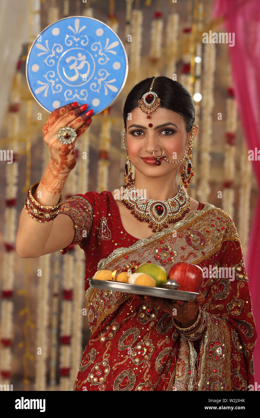Woman holding sieve with thali Stock Photo Alamy