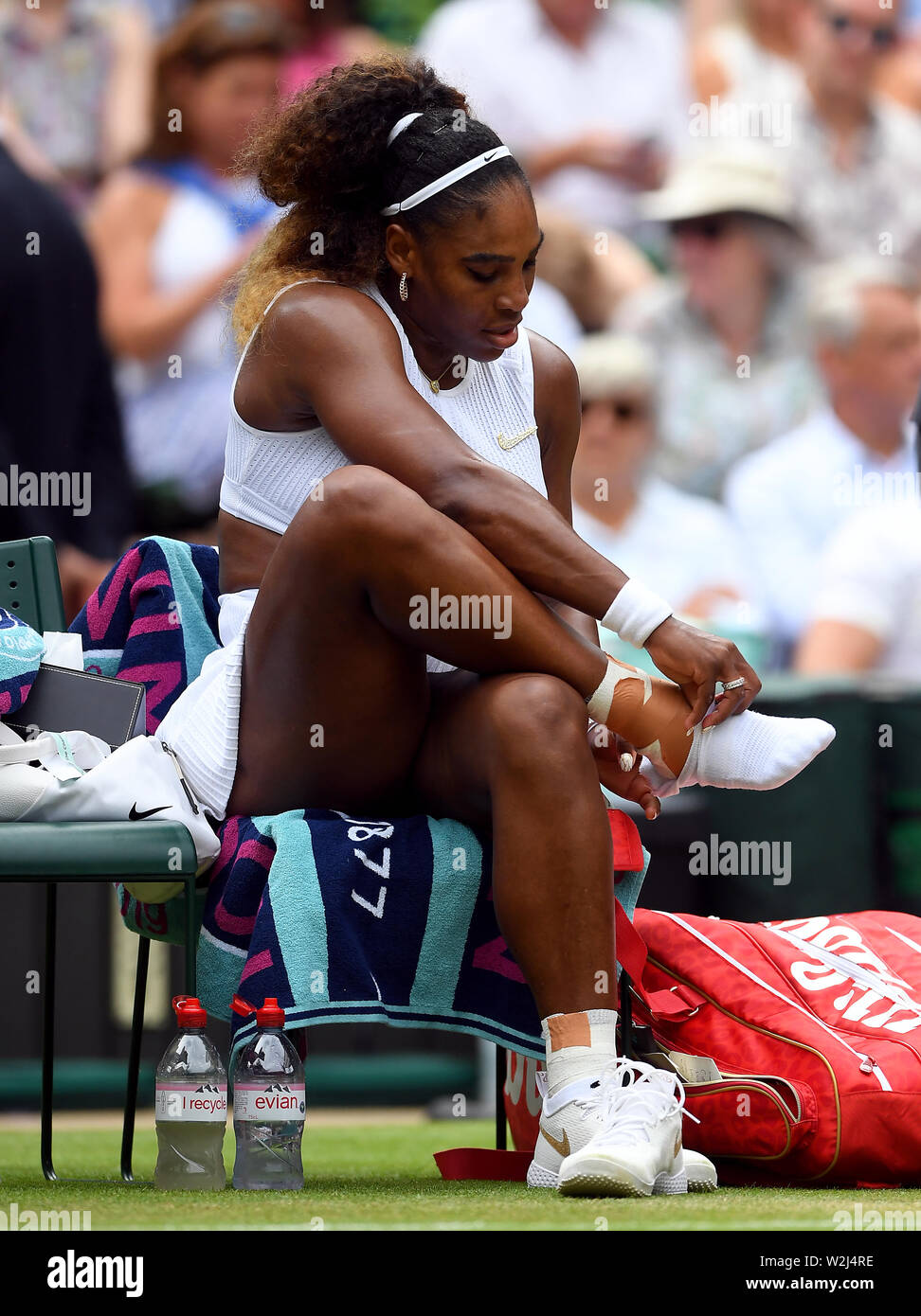 Serena Williams puts her socks and trainers back on after receiving  treatment during her match on day eight of the Wimbledon Championships at  the All England Lawn Tennis and Croquet Club, Wimbledon