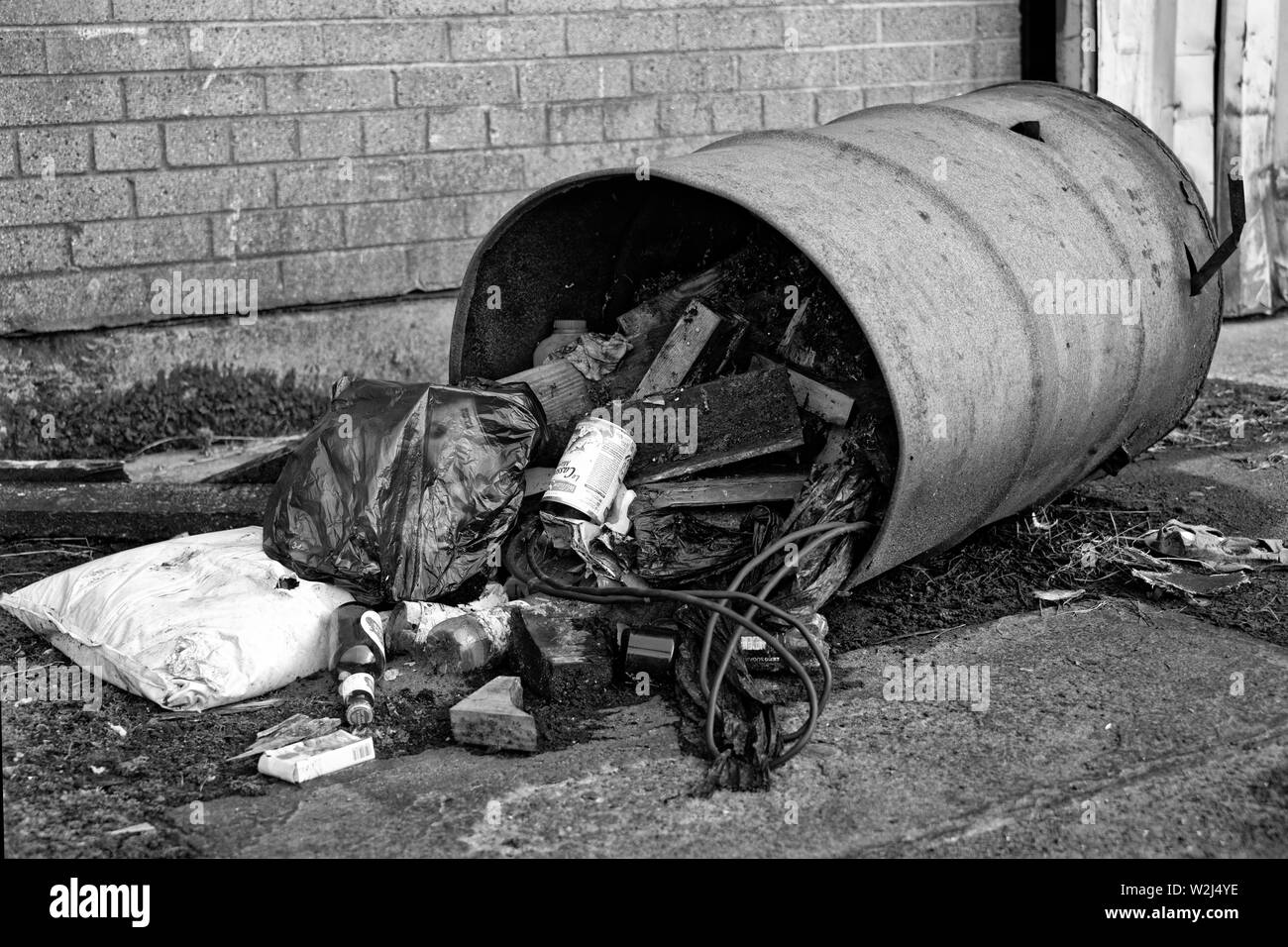 Trash in the city. Overflowing trash can in the city. Trash Barrel