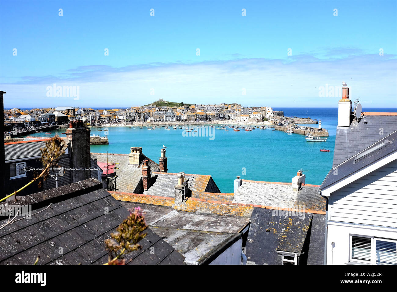 St. Ives, Cornwall, UK. June 30, 2019. The seaside town and harbor taken over the rooftops at St. Ives in Cornwall, UK. Stock Photo