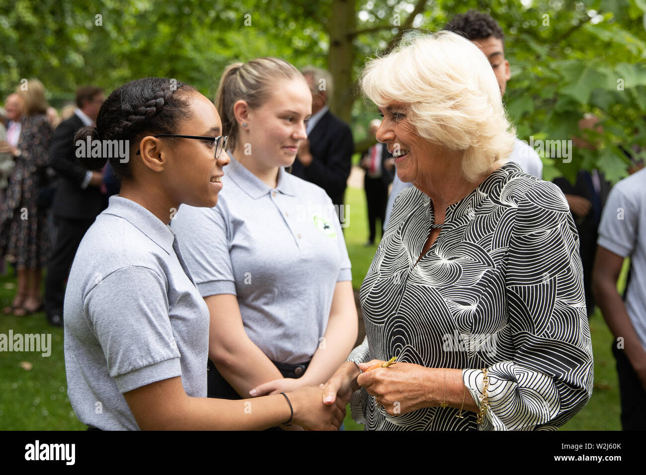 The Duchess of Cornwall meets young people who have taken part in programs with the Ebony Horse club charity during a reception for Ebony Horse Club at Clarence House in London. Stock Photo