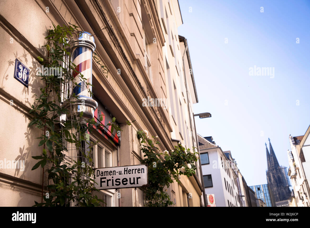 hairdresser on Dom streat, barberpole, view to the cathedral, Cologne, Germany.  Friseur in der Domstrasse, Barberpole, Blick zum Doms, Koeln, Deutsch Stock Photo