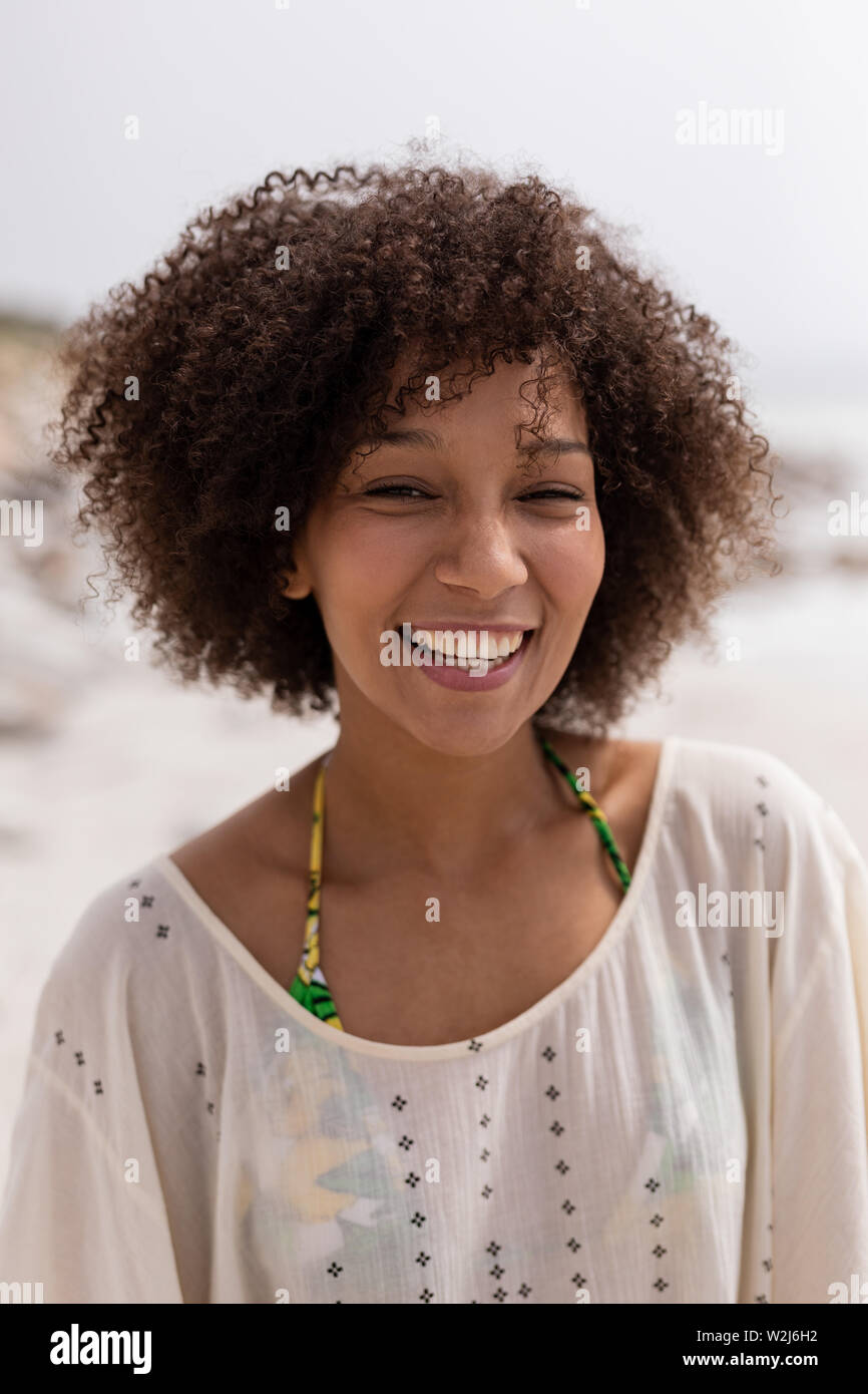 Happy african woman standing hi-res stock photography and images - Alamy