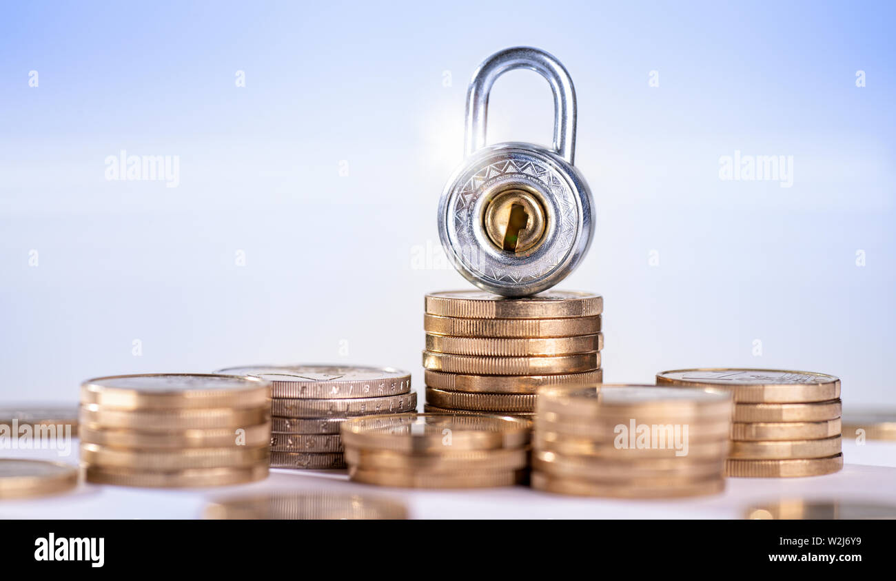 Lock with several stacks of coins Stock Photo