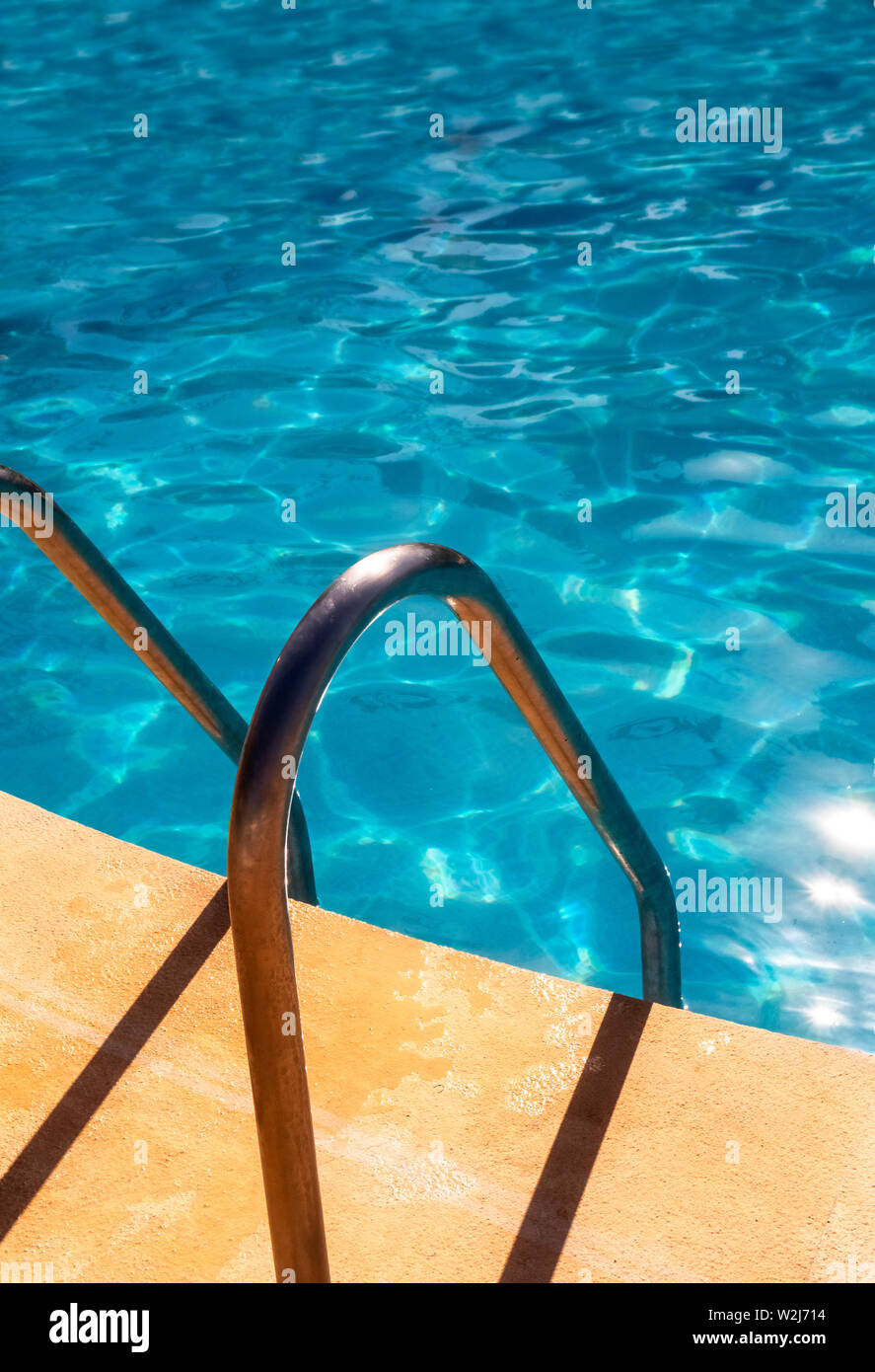 Entry into a swimming pool with grab handles Stock Photo