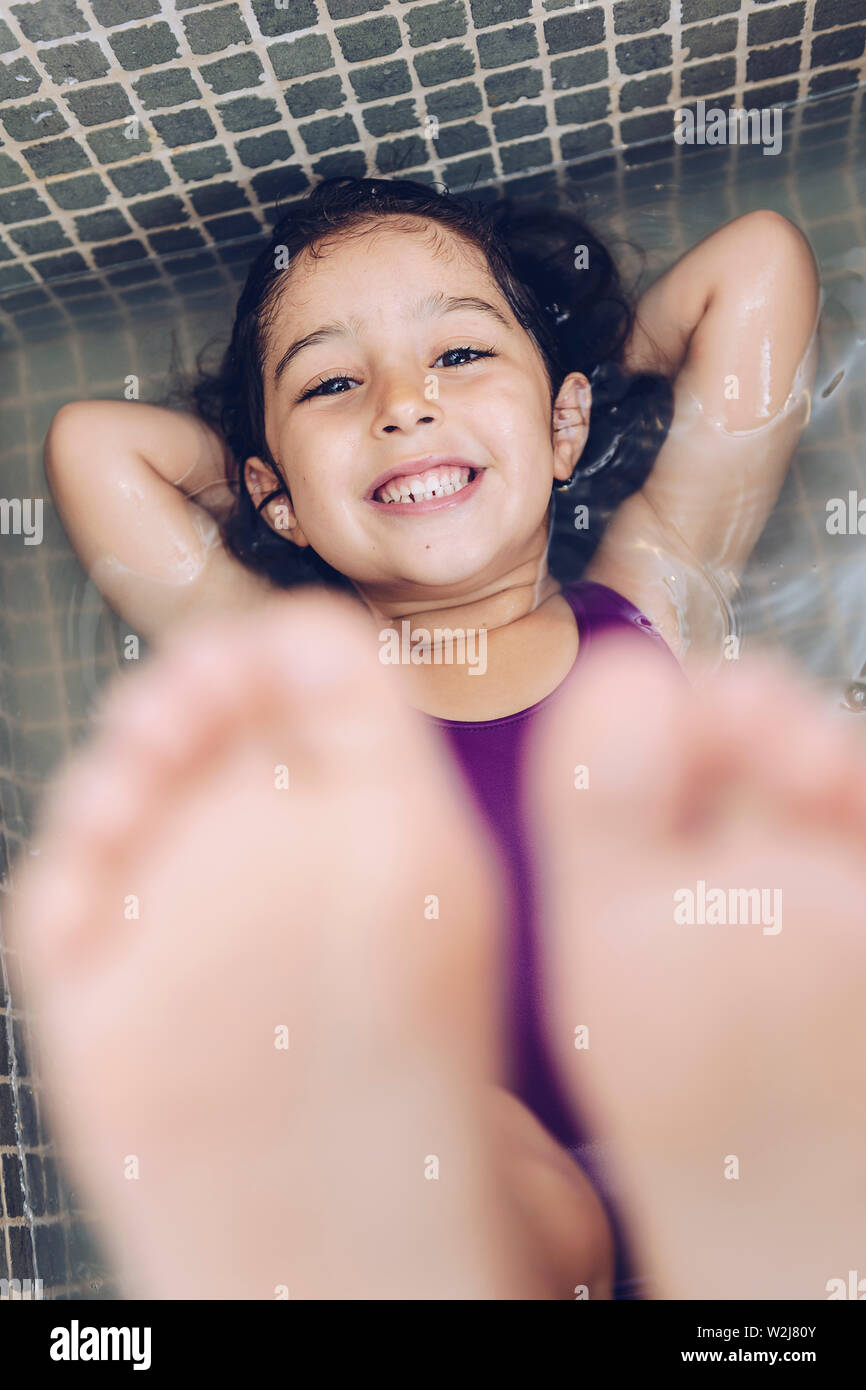 Vertical Photo Of A Playful Beautiful Little Girl Having Fun