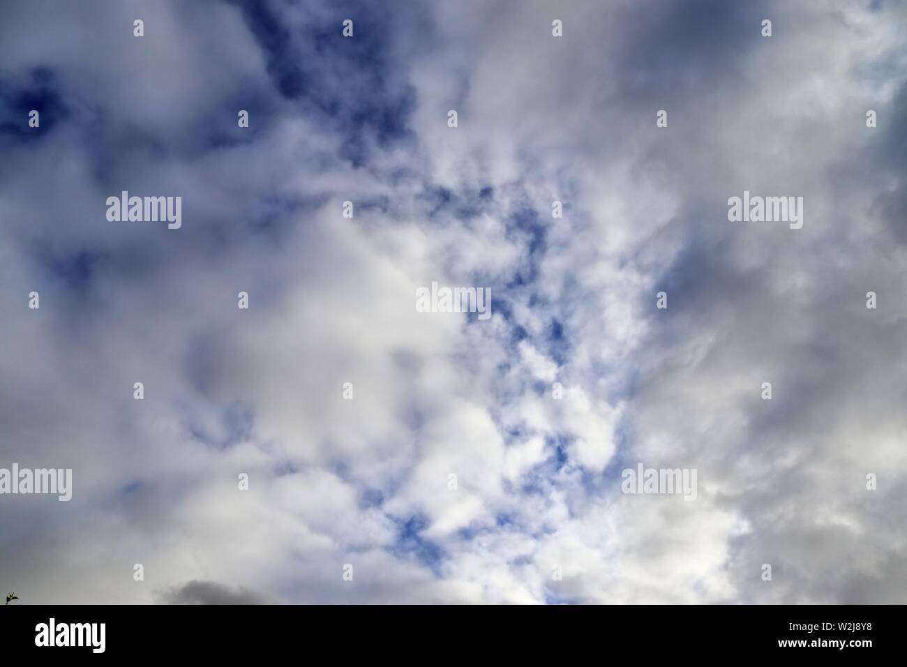 Beautiful white cumulus clouds on a deep blue sky Stock Photo - Alamy
