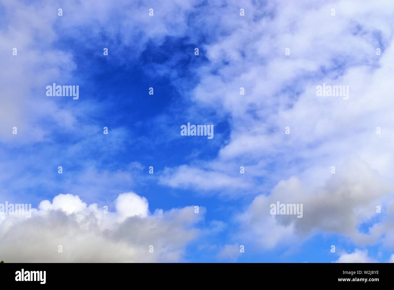 Beautiful white cumulus clouds on a deep blue sky Stock Photo - Alamy