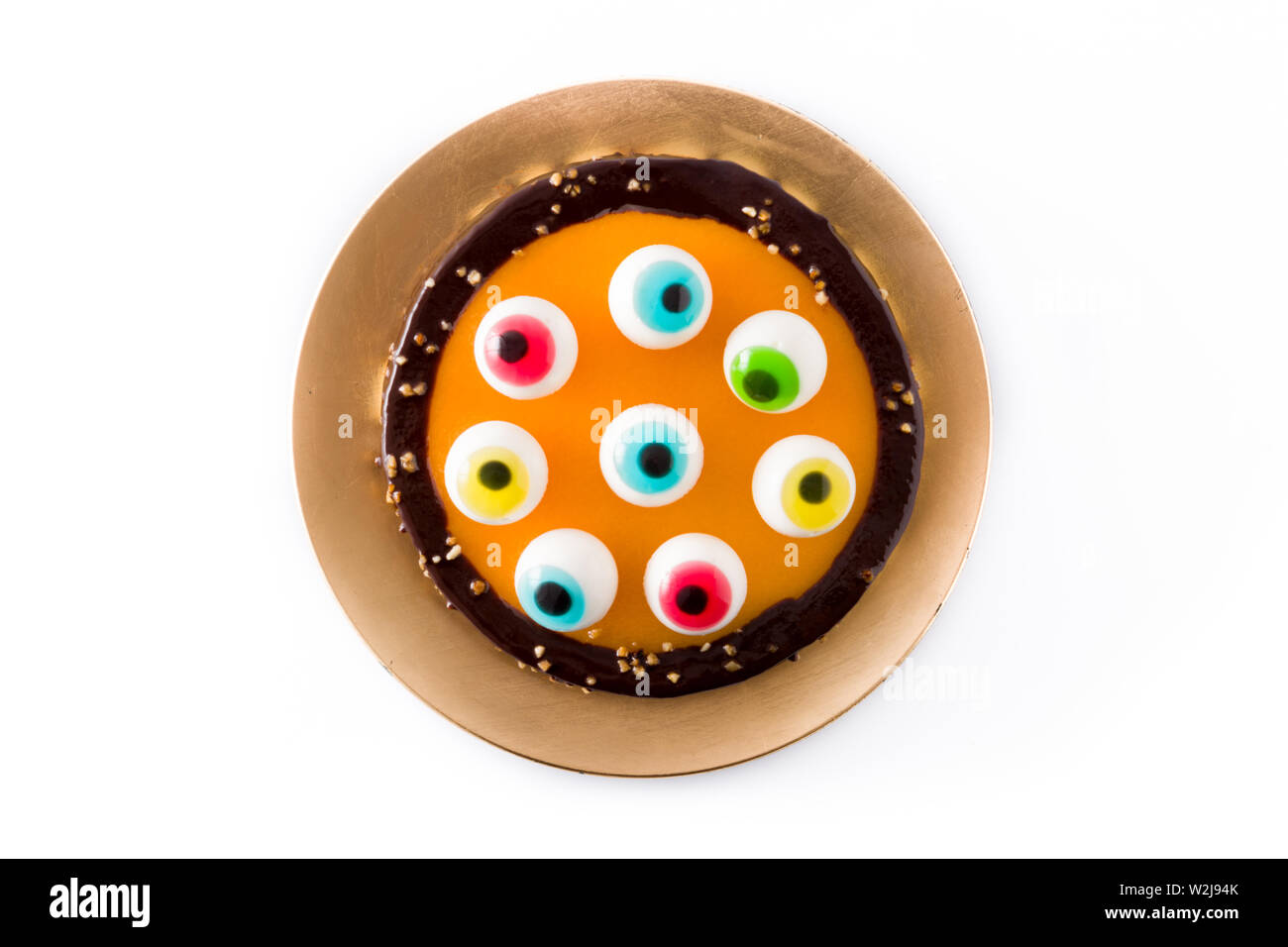 Halloween cake with candy eyes decoration isolated on white background