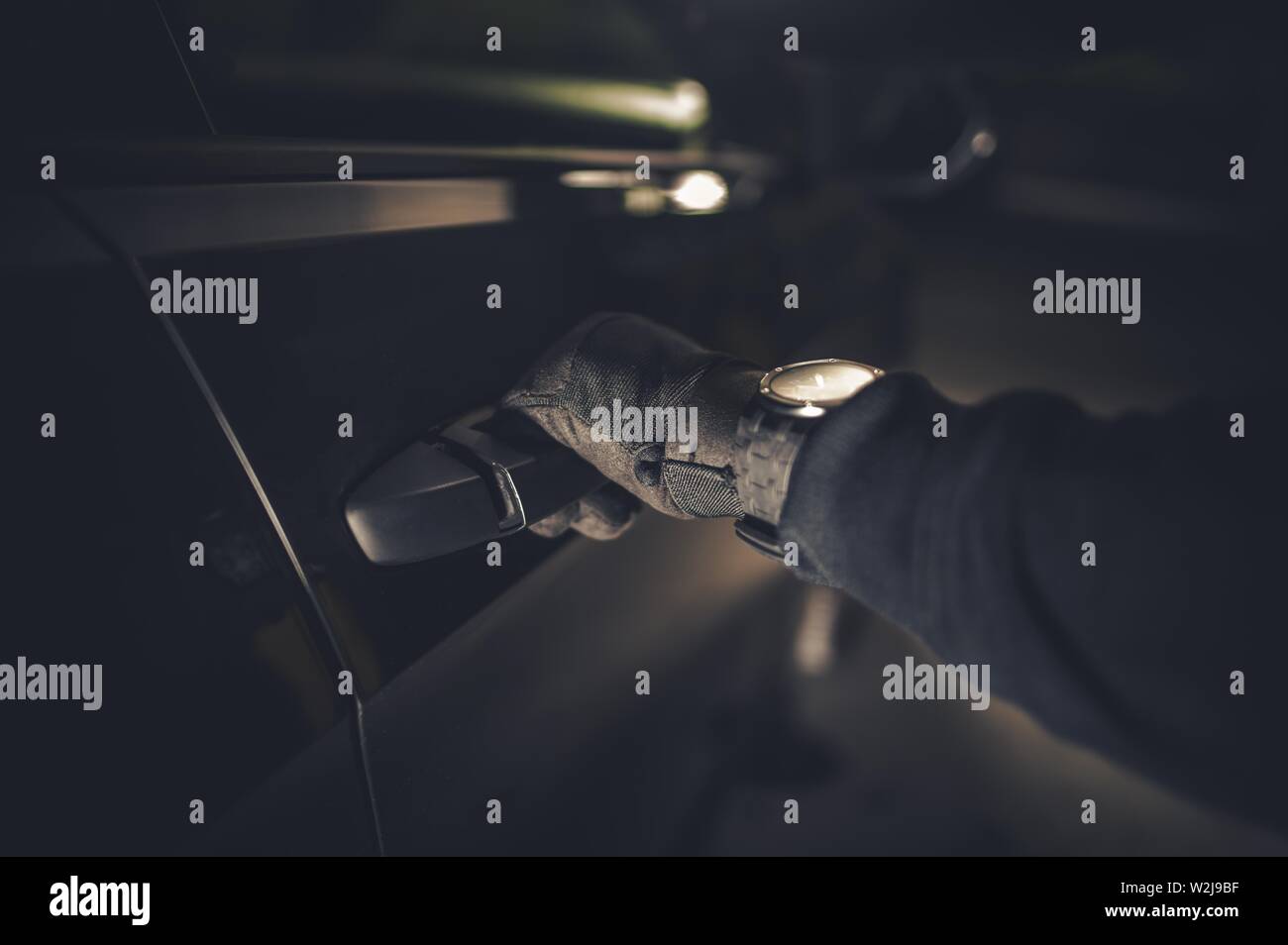Car Thief Hand on a Door Handle. Grand Theft Auto Concept. Automotive Theme. Stock Photo