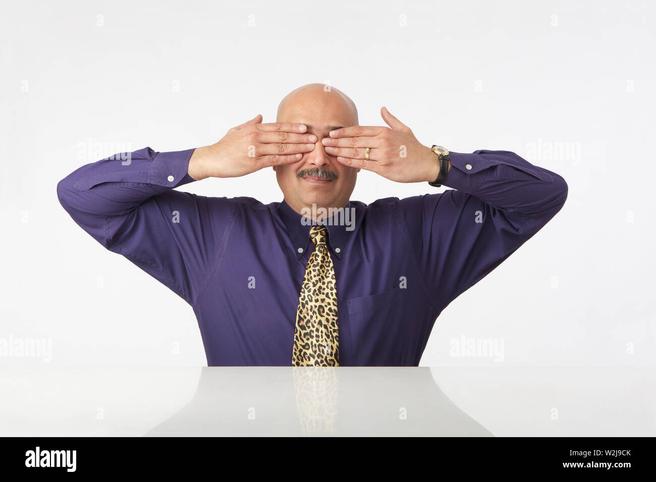 Indian businessman covering eyes with hands Stock Photo Alamy