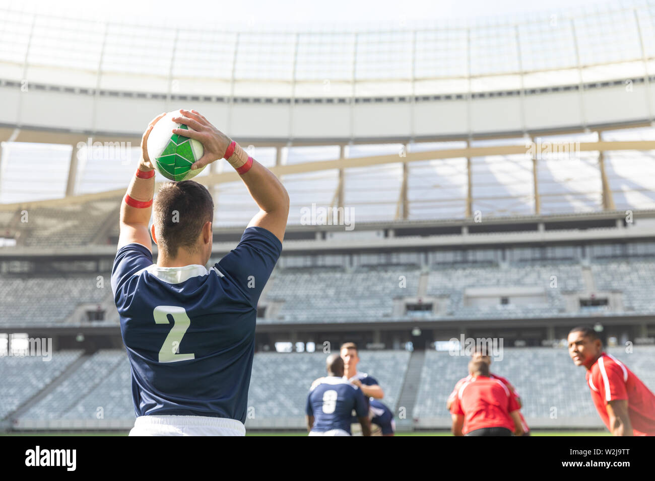 Male rugby player throwing rugby ball in stadium Stock Photo Alamy