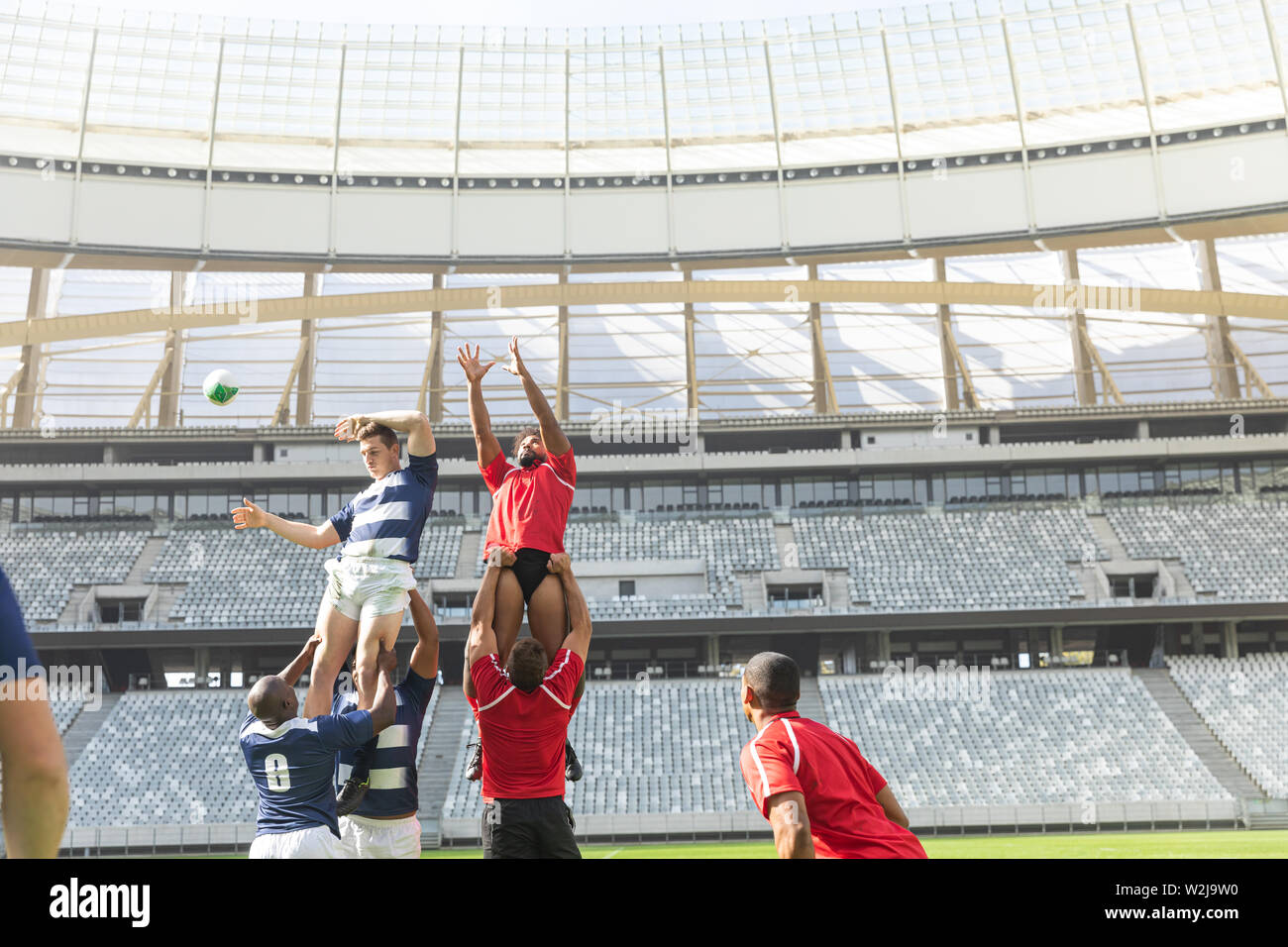 Male rugby players playing rugby match in stadium Stock Photo - Alamy