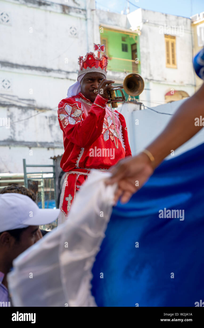 Old Havana, Cuba - January 2, 2019: Stilts performers and musicians start an impromptu street party in the streets of Havana. Stock Photo