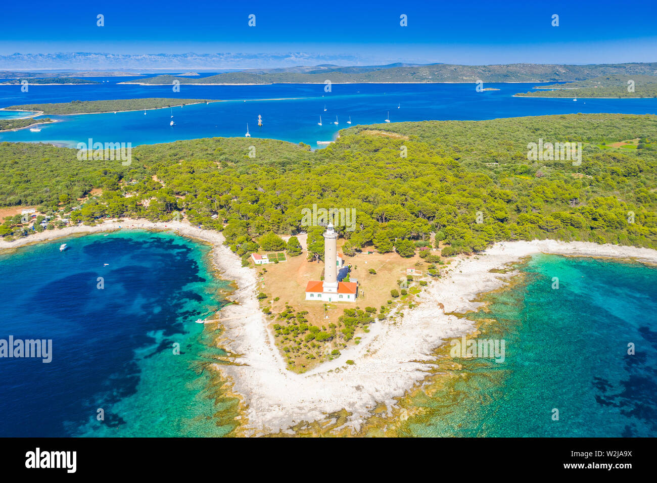 Lighthouse of Veli Rat on the stone shore on the island of Dugi Otok, Croatia, beautiful seascape Stock Photo
