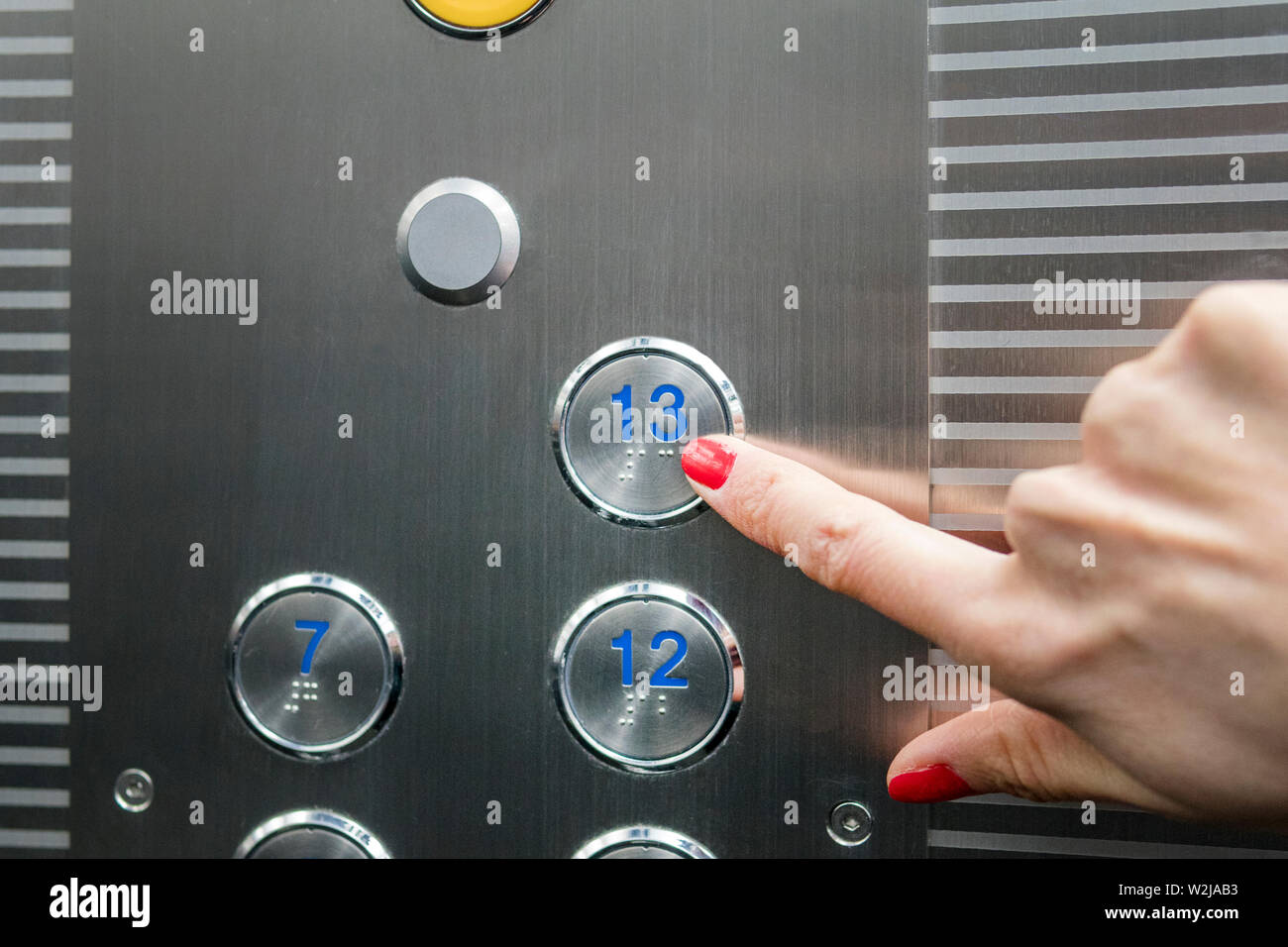 Woman In Elevator Or Lift Is Pressing The Button To Get Into The