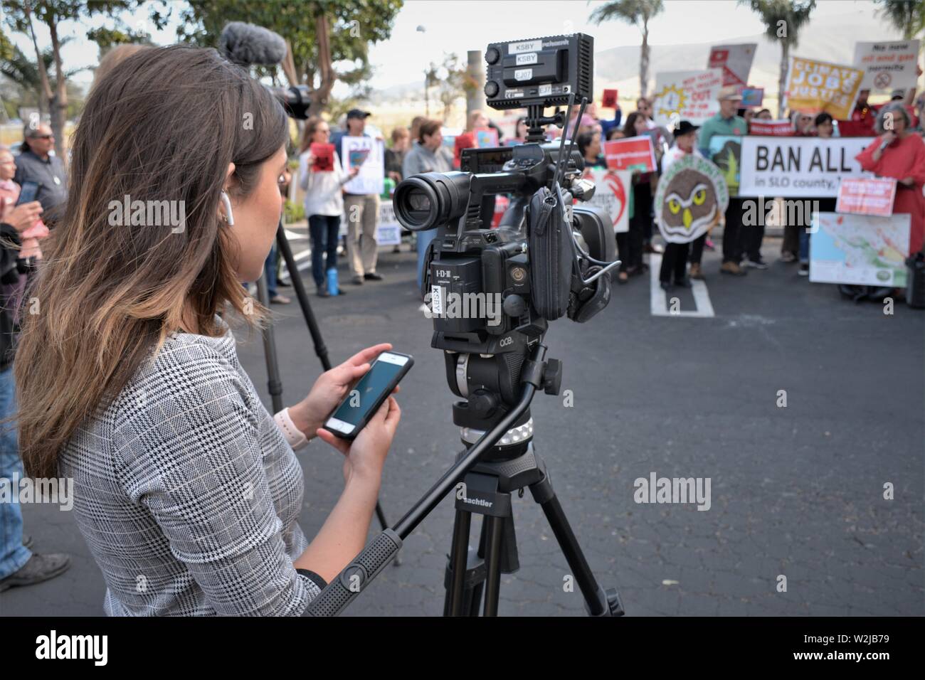 One person news television station coverage of demonstration at public demonstration about environmental fracking by oil companies public land dunes Stock Photo