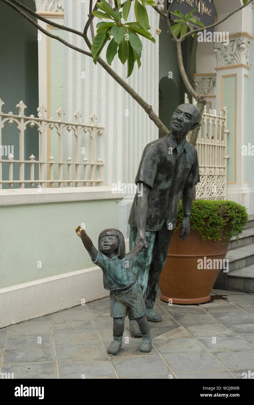 singapore, singapore - february 09, 2017: bronze statues of an old man and a young girl in front of the peranakan museum on armenian street Stock Photo