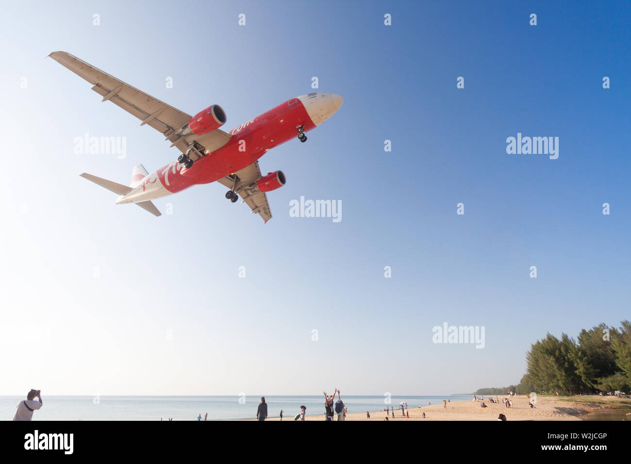 Airplane Is Landing At Phuket Airport Over The Mai Khao