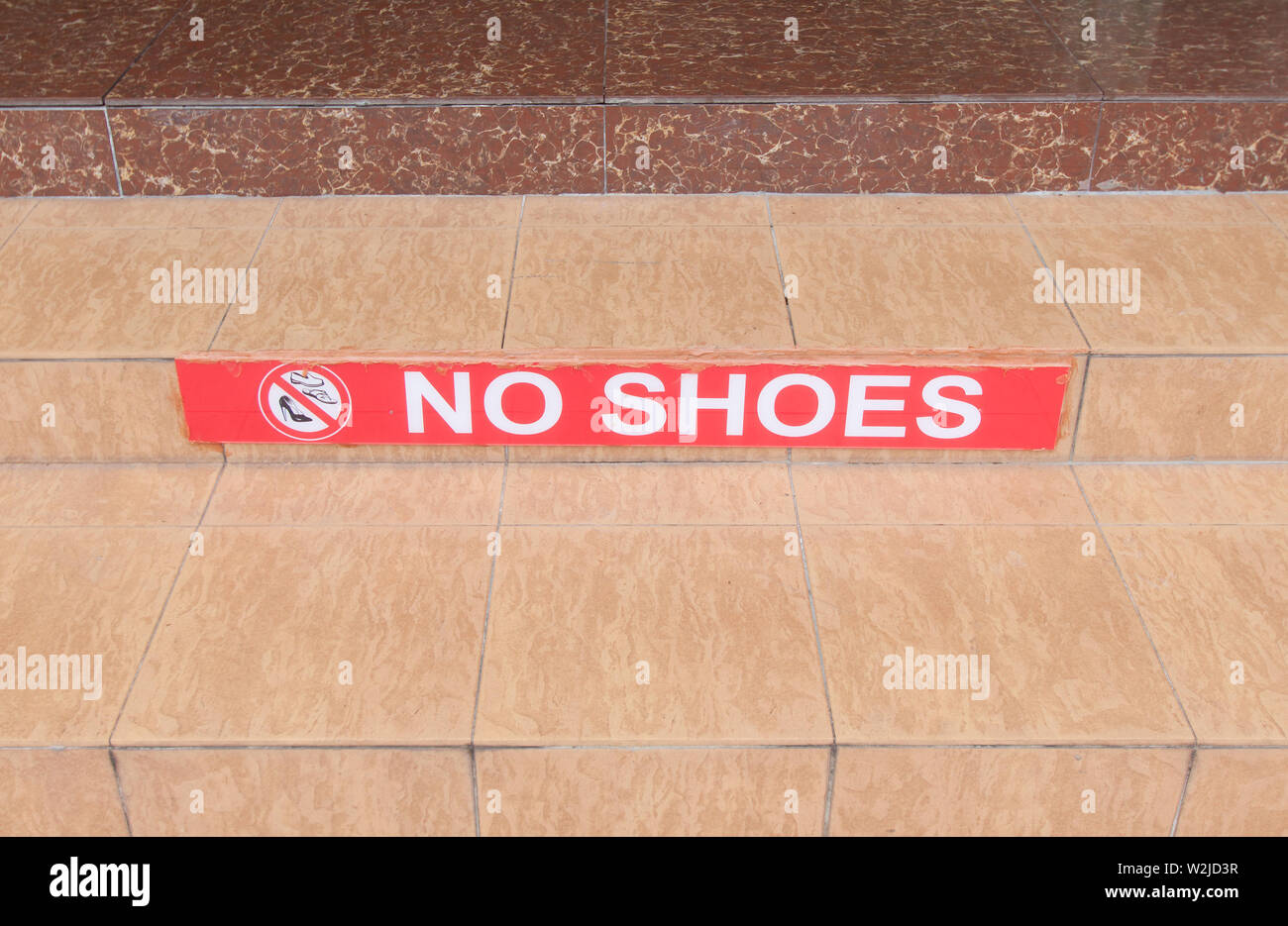 Symbol of no shoes on stair. Stock Photo