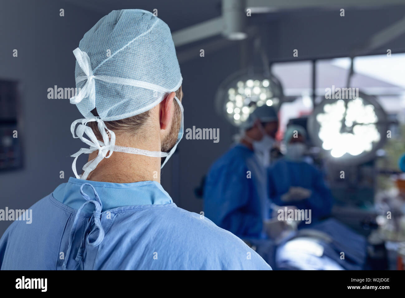 Male surgeon standing in operation room at hospital Stock Photo