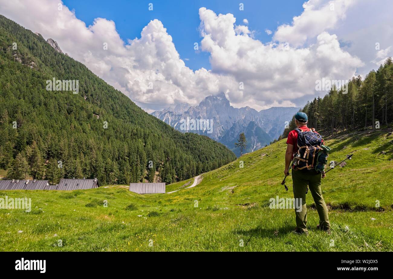 Hiker walk on trail and admiring the panorama. Italy Alps. Stock Photo