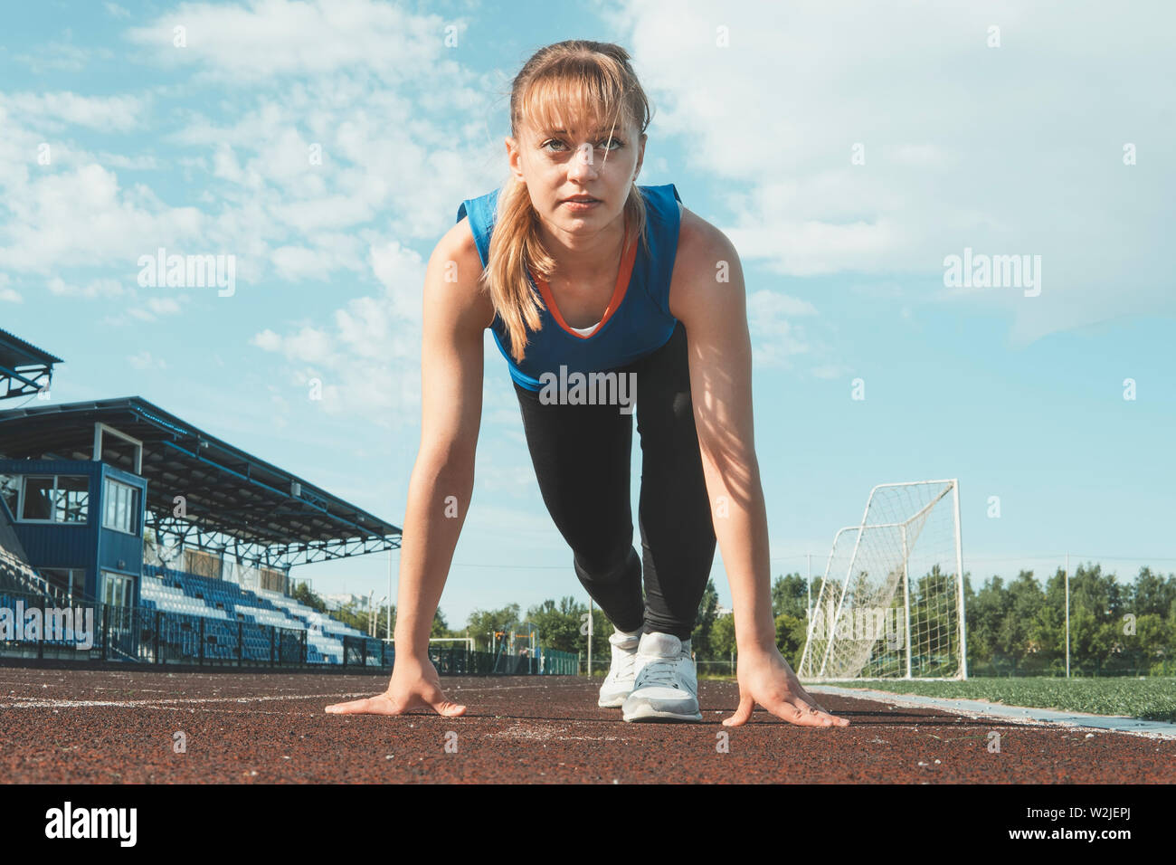 Young Girl Runner feet on track closeup focus on sport shoe. Getting