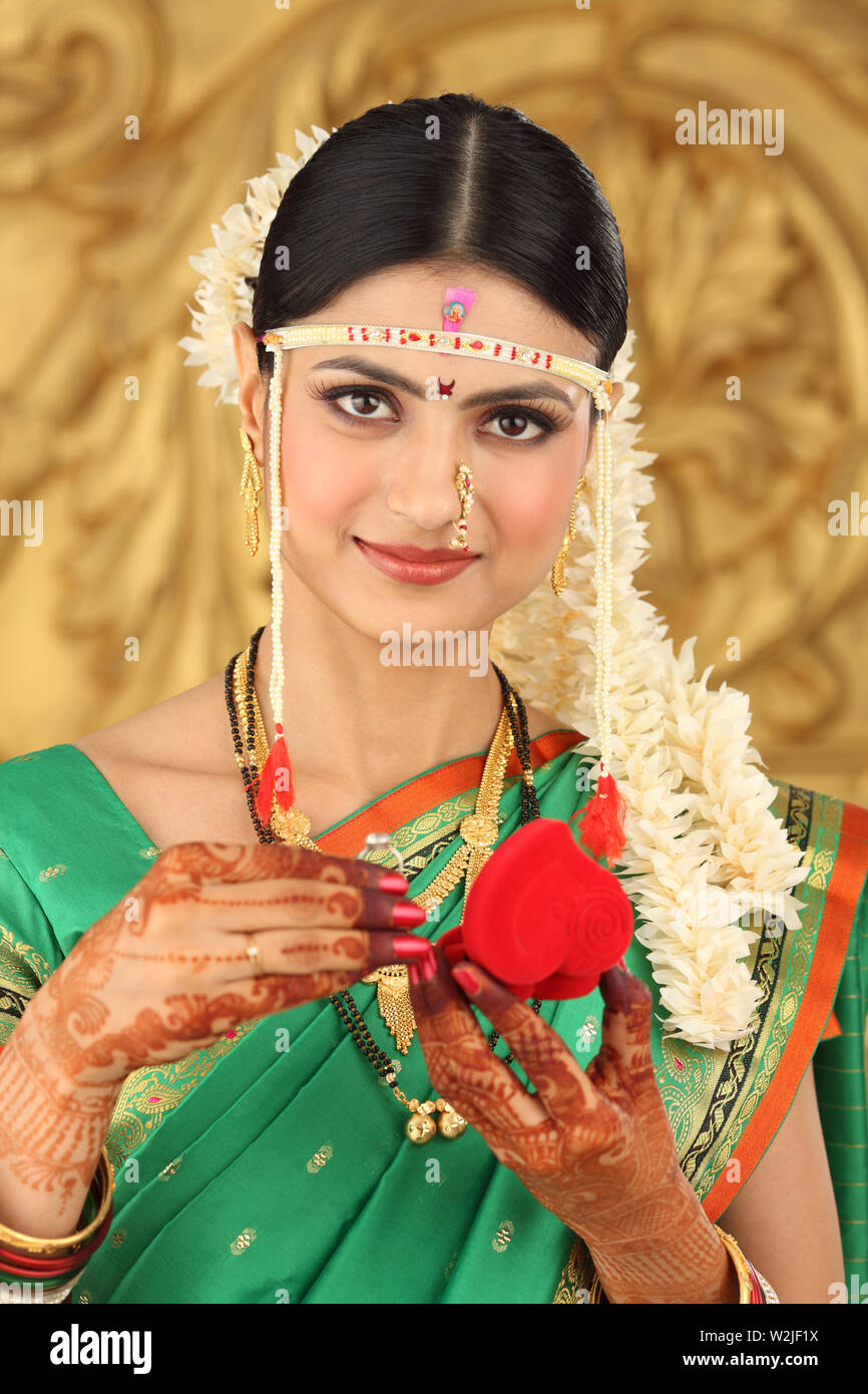 Indian bride holding wedding ring Stock Photo