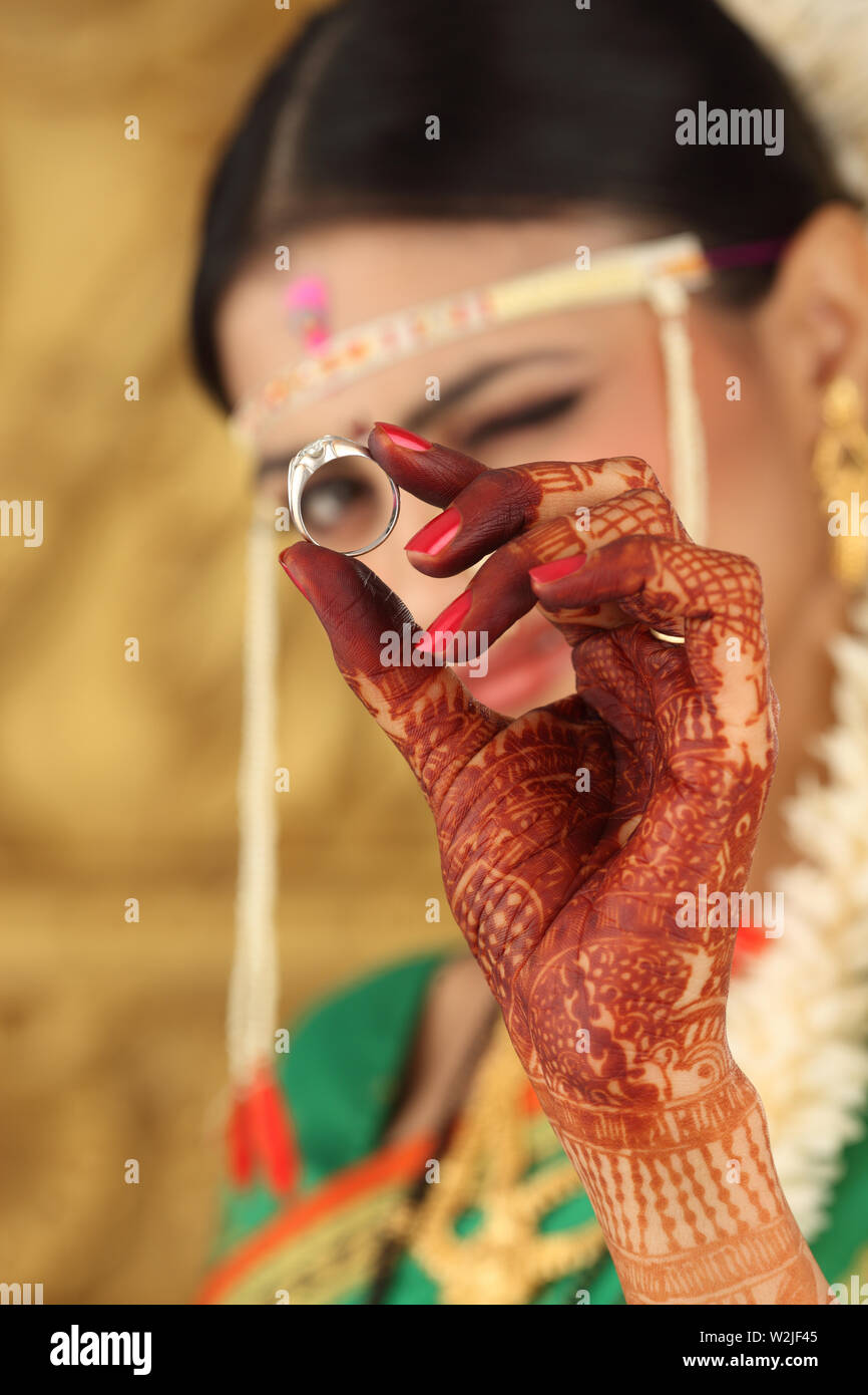 Indian bride looking through wedding ring Stock Photo Alamy