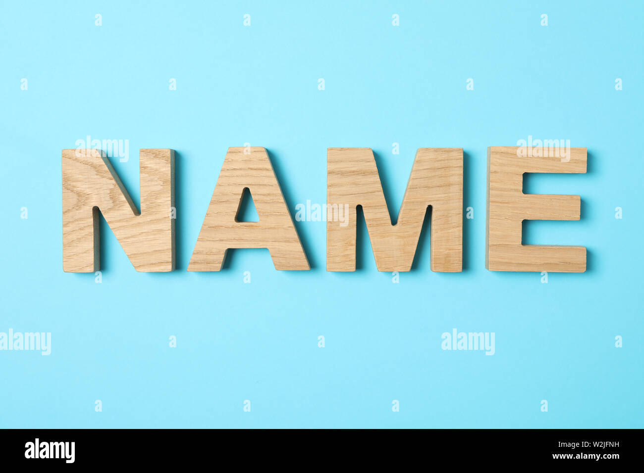 Word Name lined with wooden letters on color background Stock ...