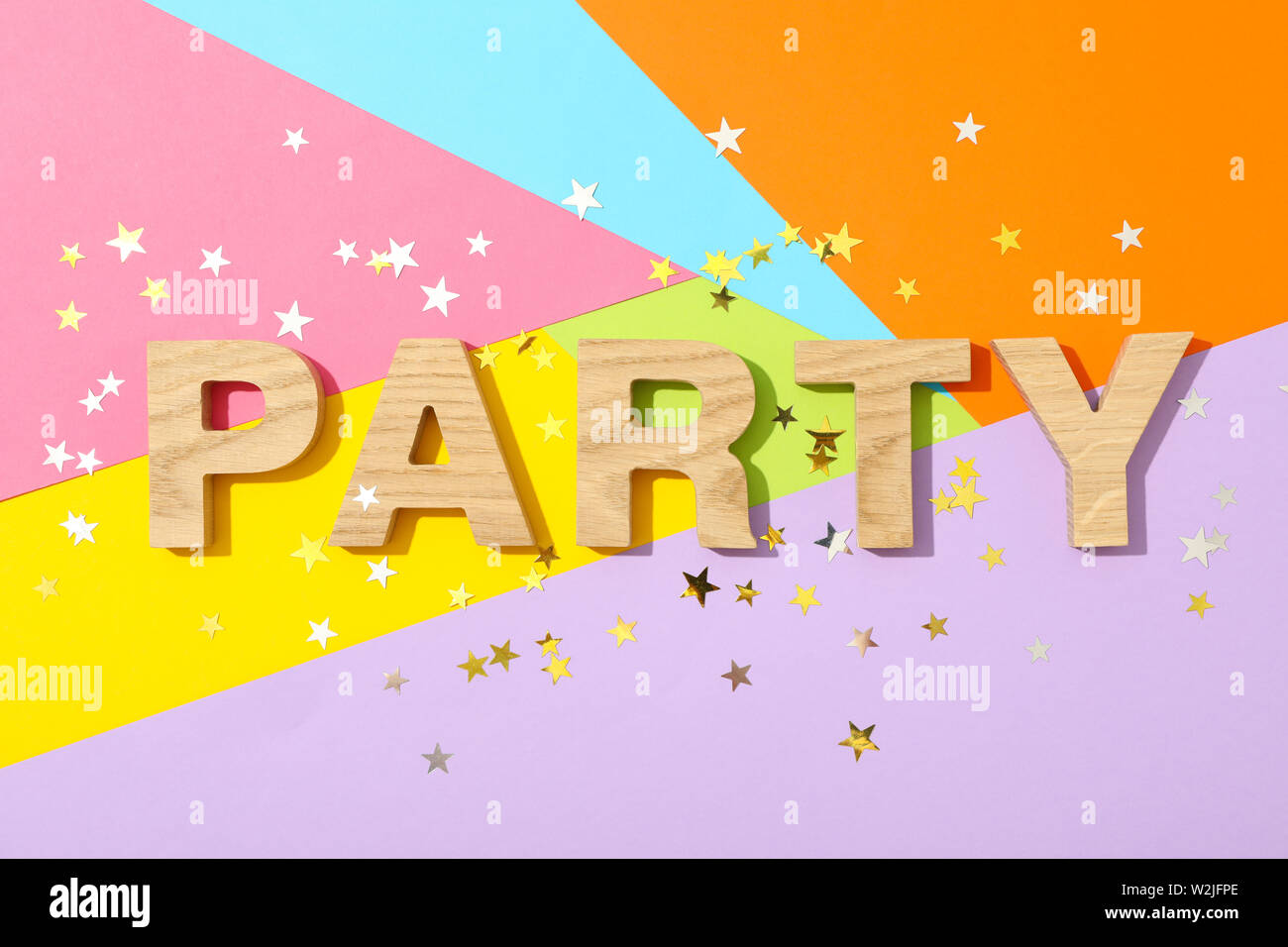 Word Party lined with wooden letters on multicolor background with