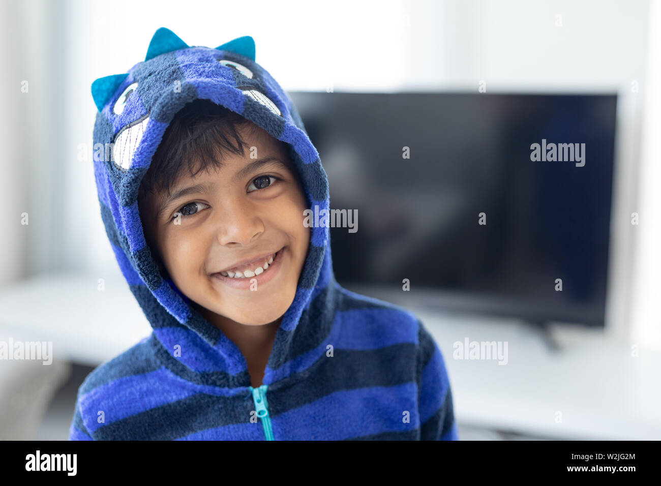 Boy smiling in living room at home Stock Photo