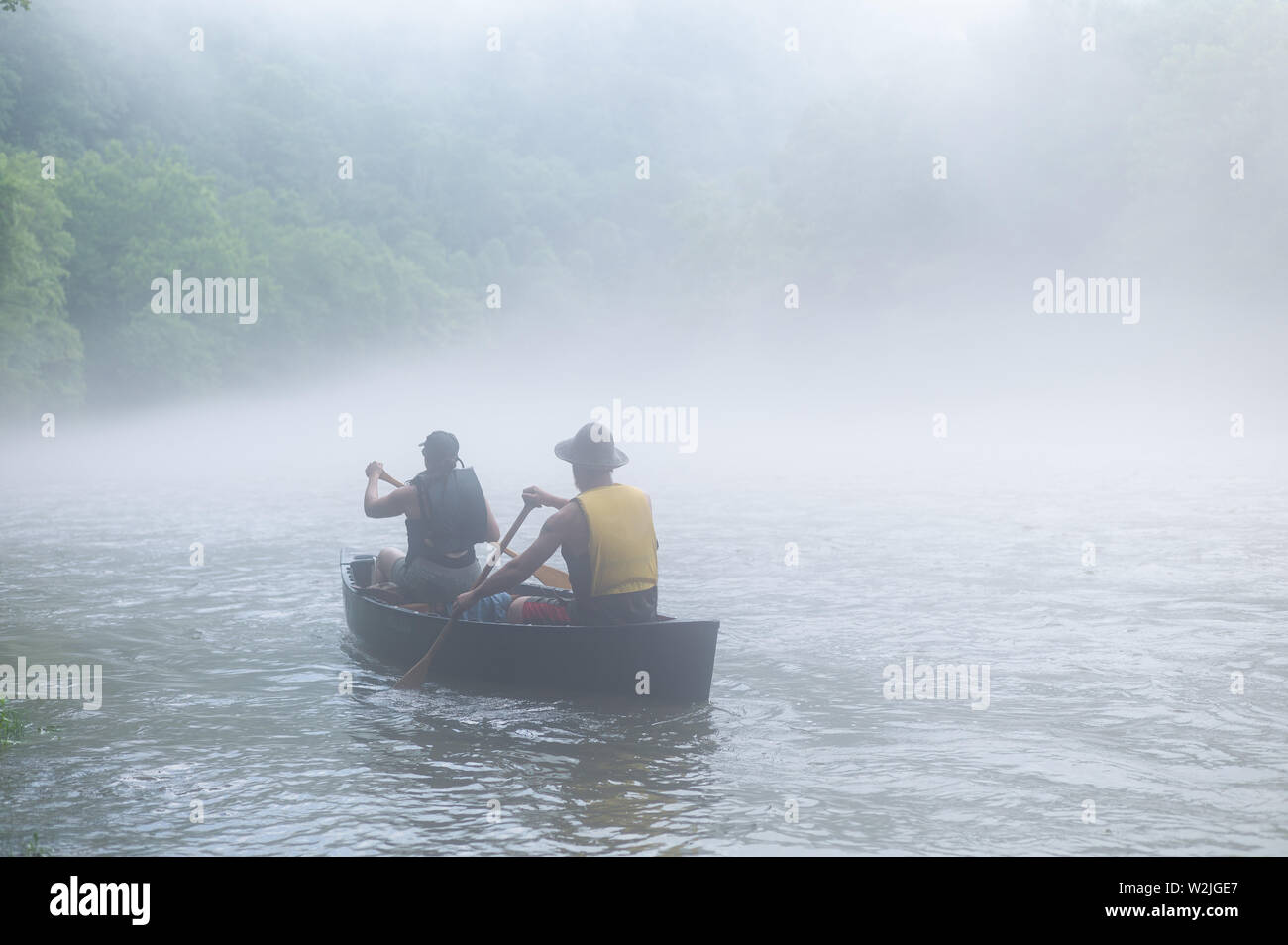 Canoes and rafts depart from a foggy Youghiogheny riverbank for a fog