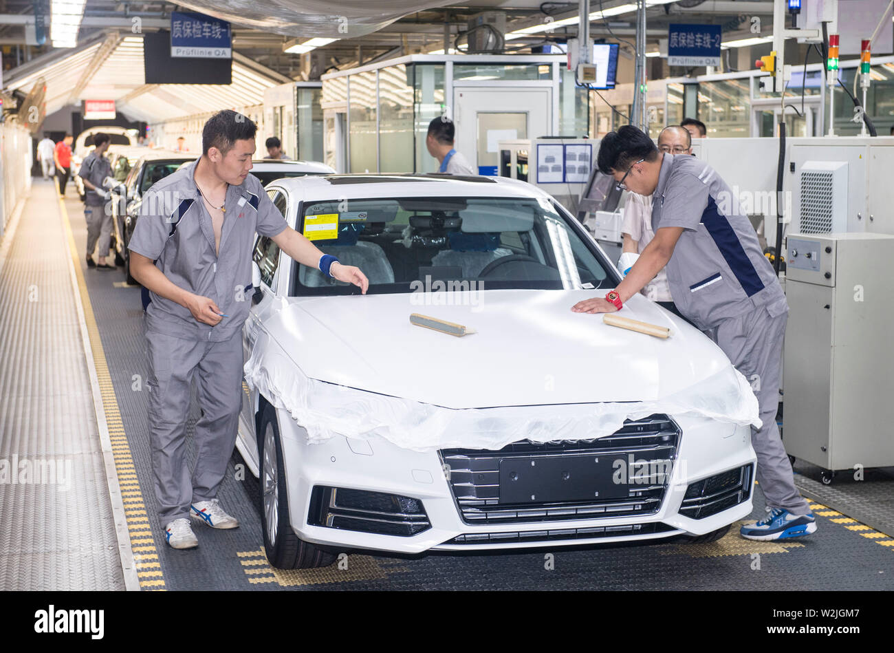 Changchun, China's Jilin Province. 9th July, 2019. Workers check vehicles at FAW-Volkswagen factory in Changchun, northeast China's Jilin Province, July 9, 2019. The Sino-German auto joint venture FAW-Volkswagen said a record 311,871 Audi vehicles were sold in China in the first half of 2019, up 2.1 percent year-on-year. Credit: Xu Chang/Xinhua/Alamy Live News Stock Photo