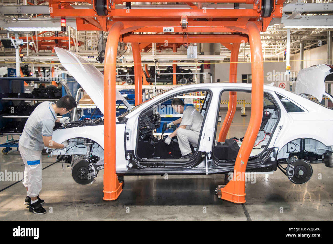 Changchun, China's Jilin Province. 9th July, 2019. Workers assembles an Audi car at FAW-Volkswagen factory in Changchun, northeast China's Jilin Province, July 9, 2019. The Sino-German auto joint venture FAW-Volkswagen said a record 311,871 Audi vehicles were sold in China in the first half of 2019, up 2.1 percent year-on-year. Credit: Xu Chang/Xinhua/Alamy Live News Stock Photo